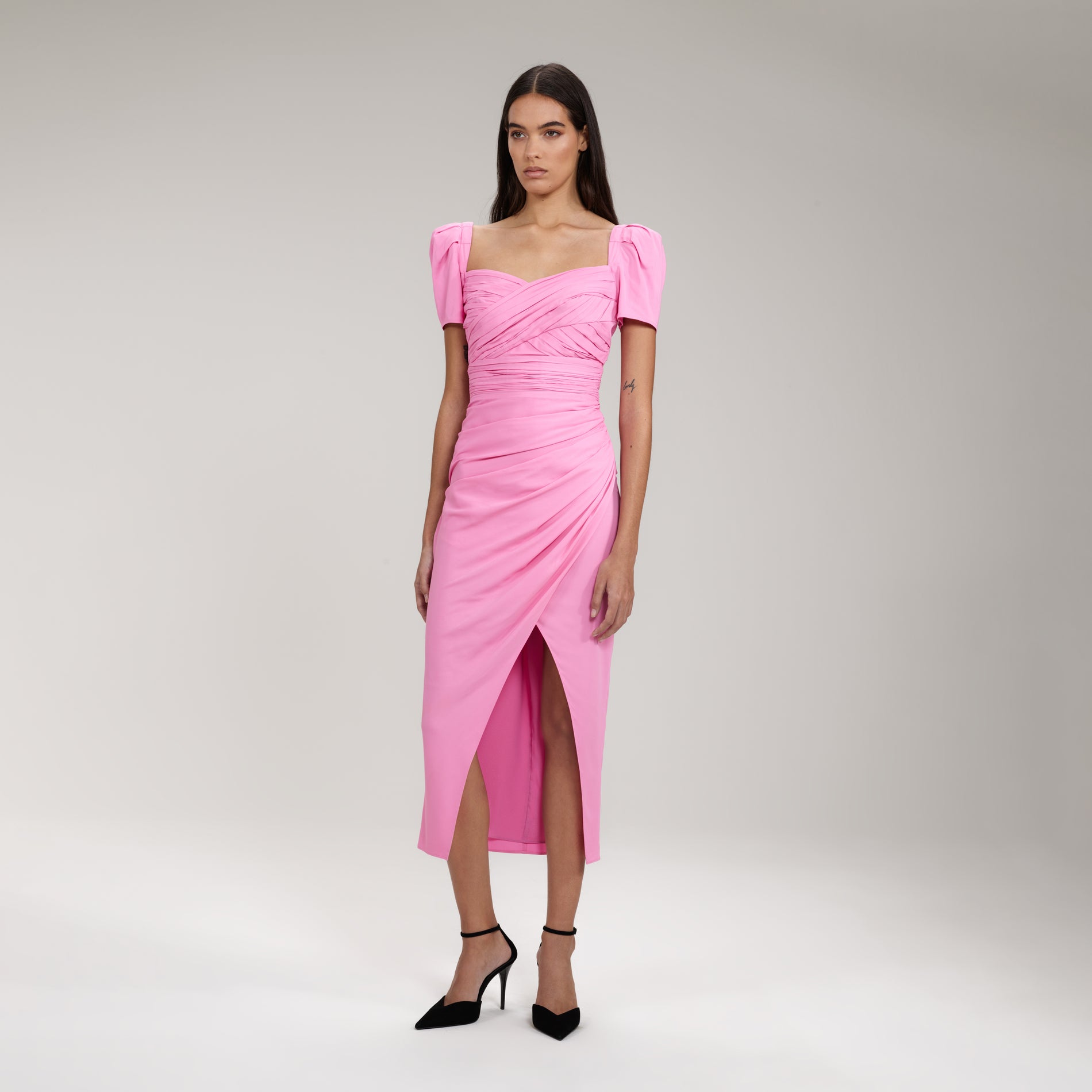 A woman wearing the Pink Iris Midi Dress