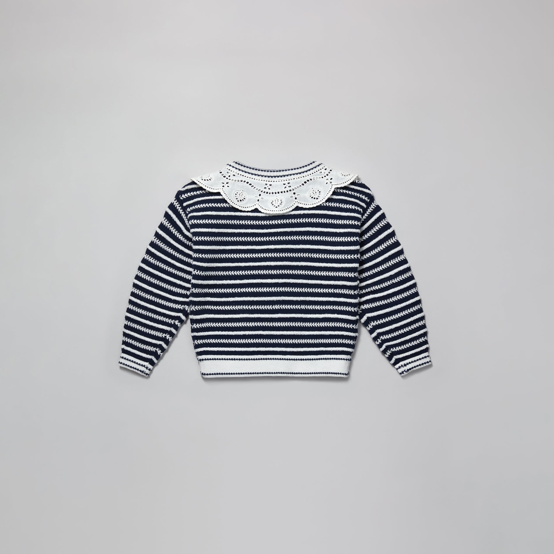 A woman wearing the Navy Contrast Rope Knit Cardigan