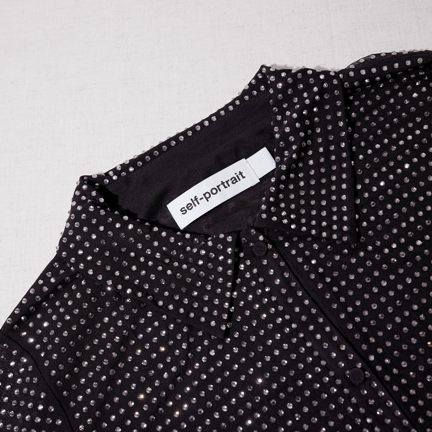 A close up of the fabric for the Black Rhinestone Mini Shirt Dress