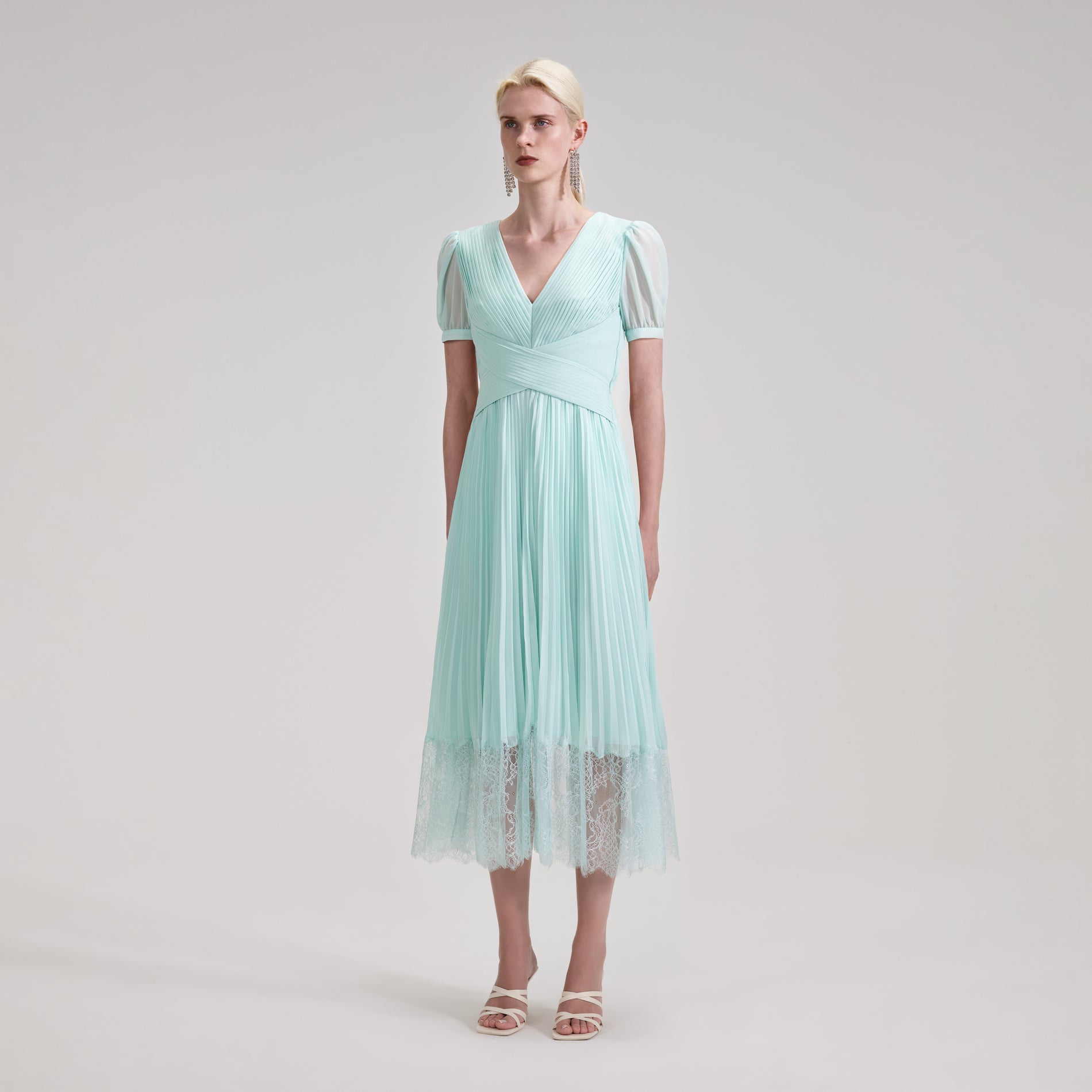 A woman wearing the Blue Chiffon Crossover Midi Dress