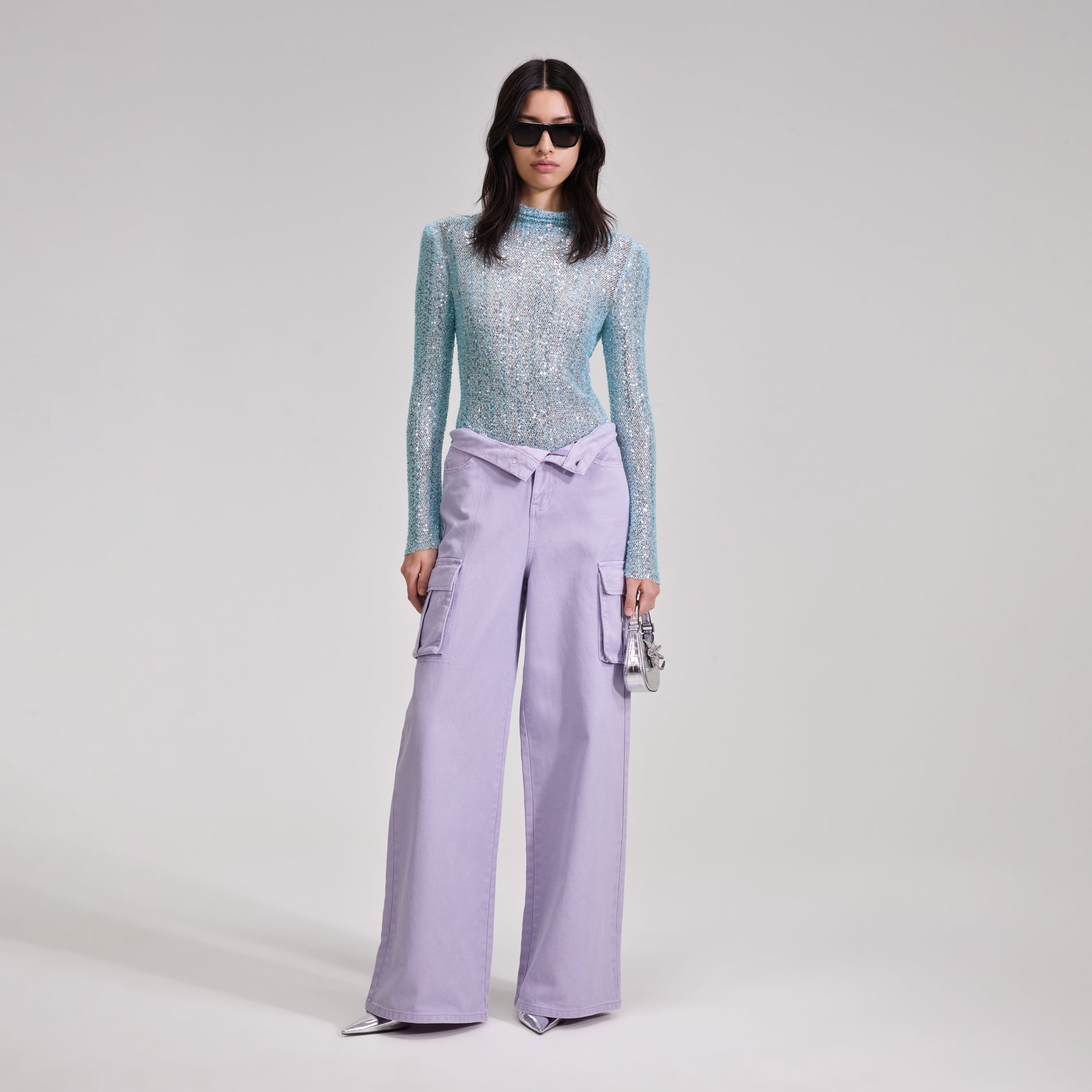 A woman wearing the Blue Beaded Top