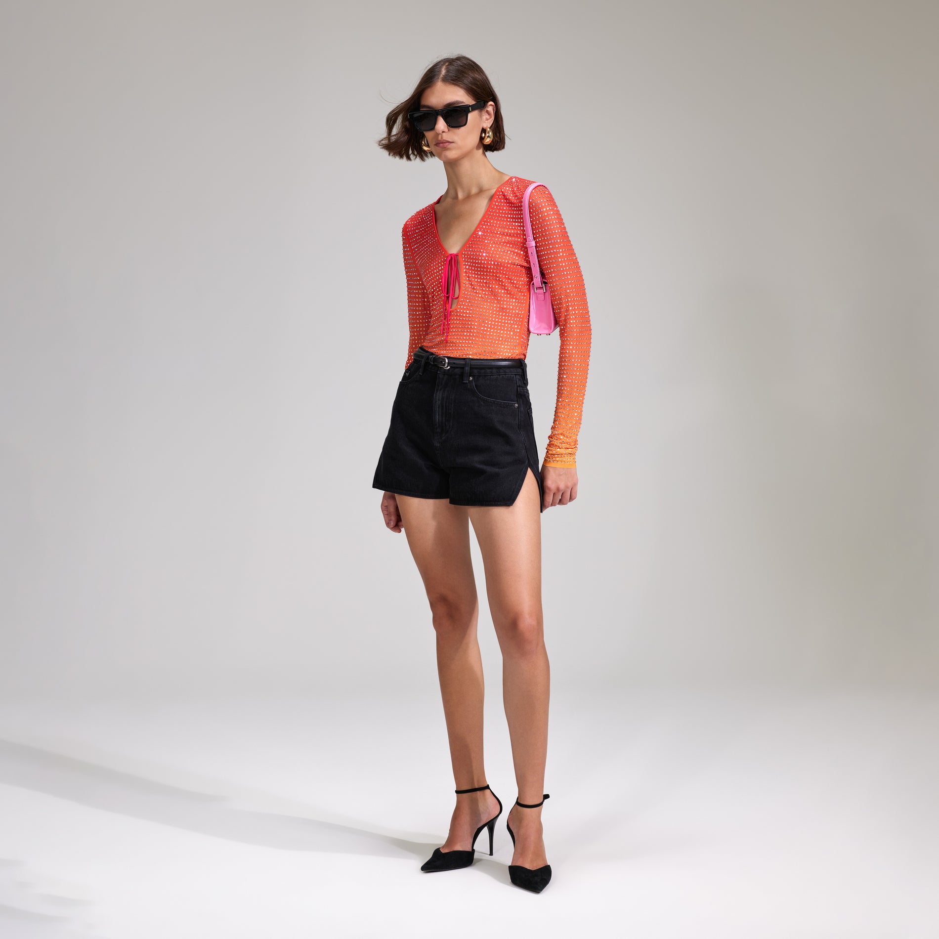 A woman wearing the Pink Rhinestone Mesh Keyhole Top