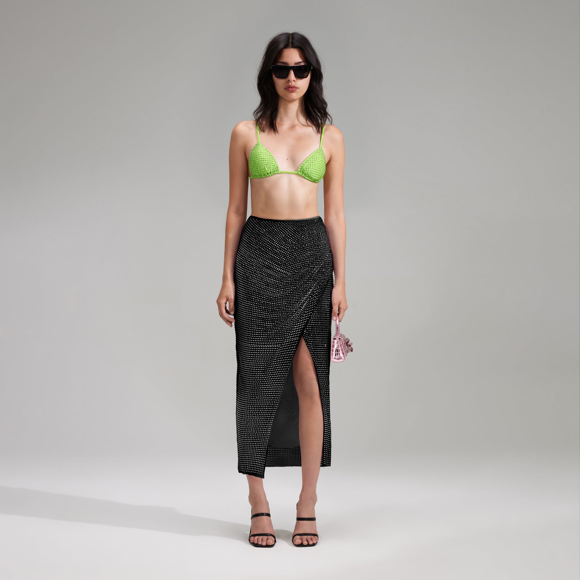 A woman wearing the Green Rhinestone Triangle Bikini Top
