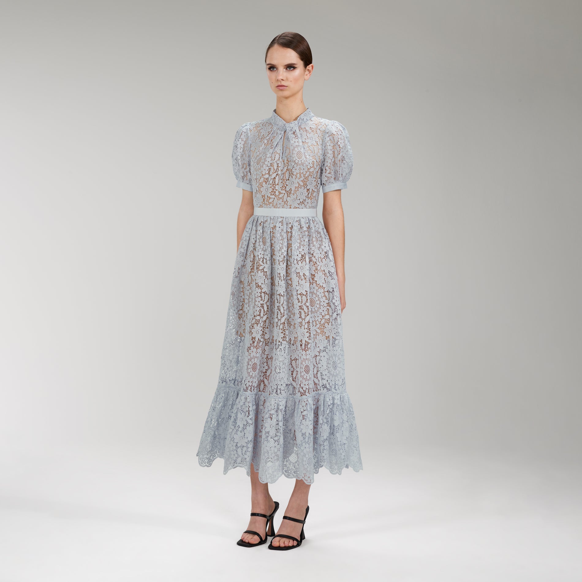 A woman wearing the Blue Guipure Lace Midi Dress