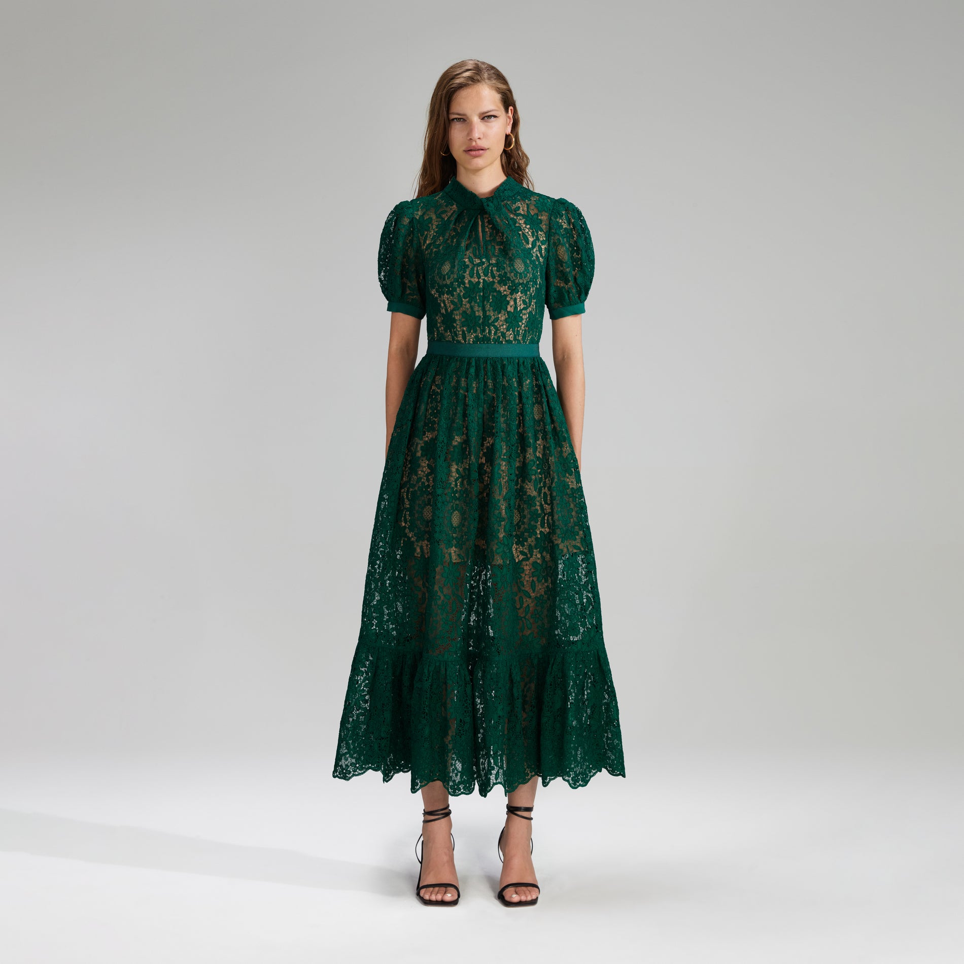 A woman wearing the Green Guipure Lace Midi Dress