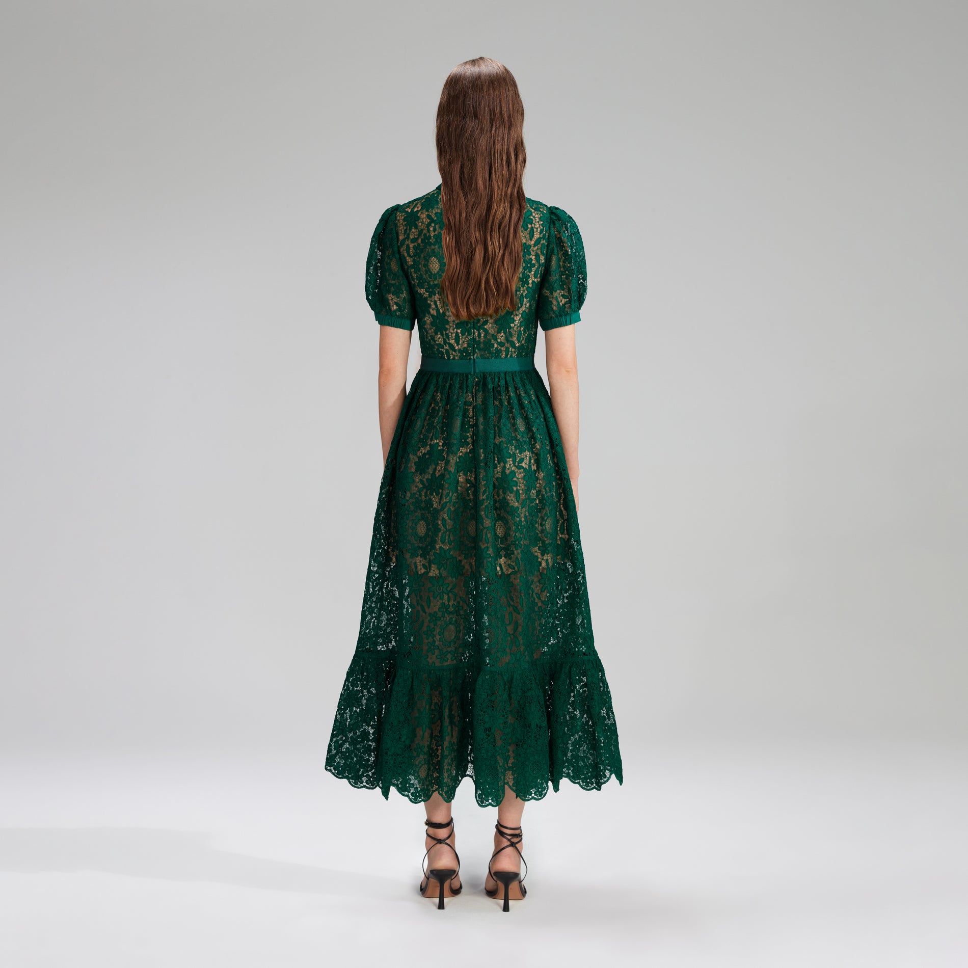 A woman wearing the Green Guipure Lace Midi Dress