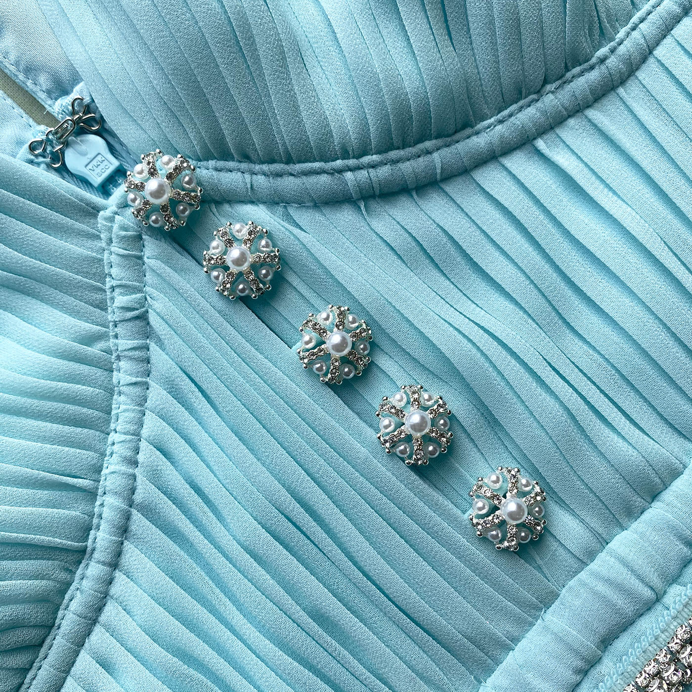 A close up of the fabric for the Blue Chiffon Diamanté Button Midi Dress