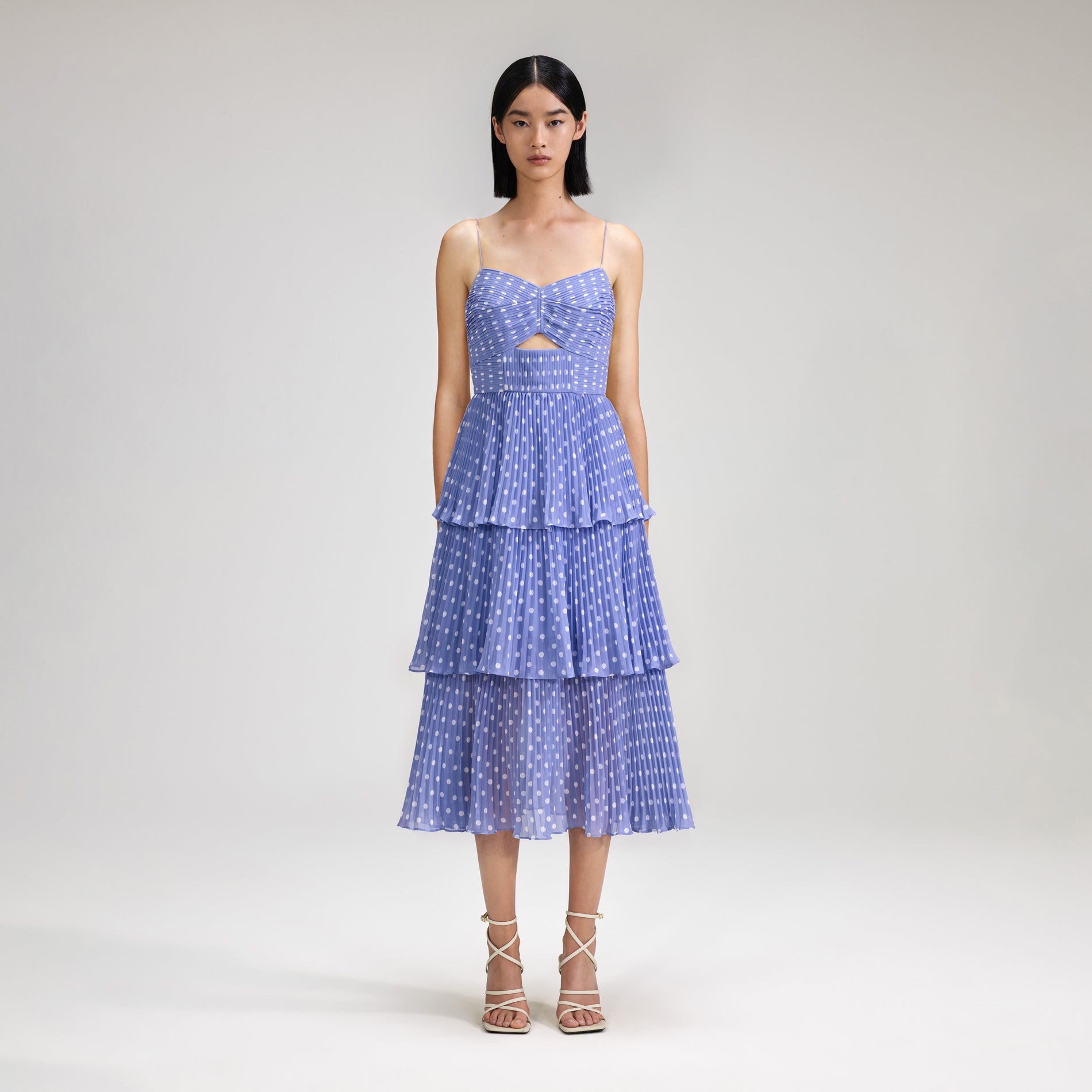 A woman wearing the Lilac Polka Dot Tiered Chiffon Midi Dress