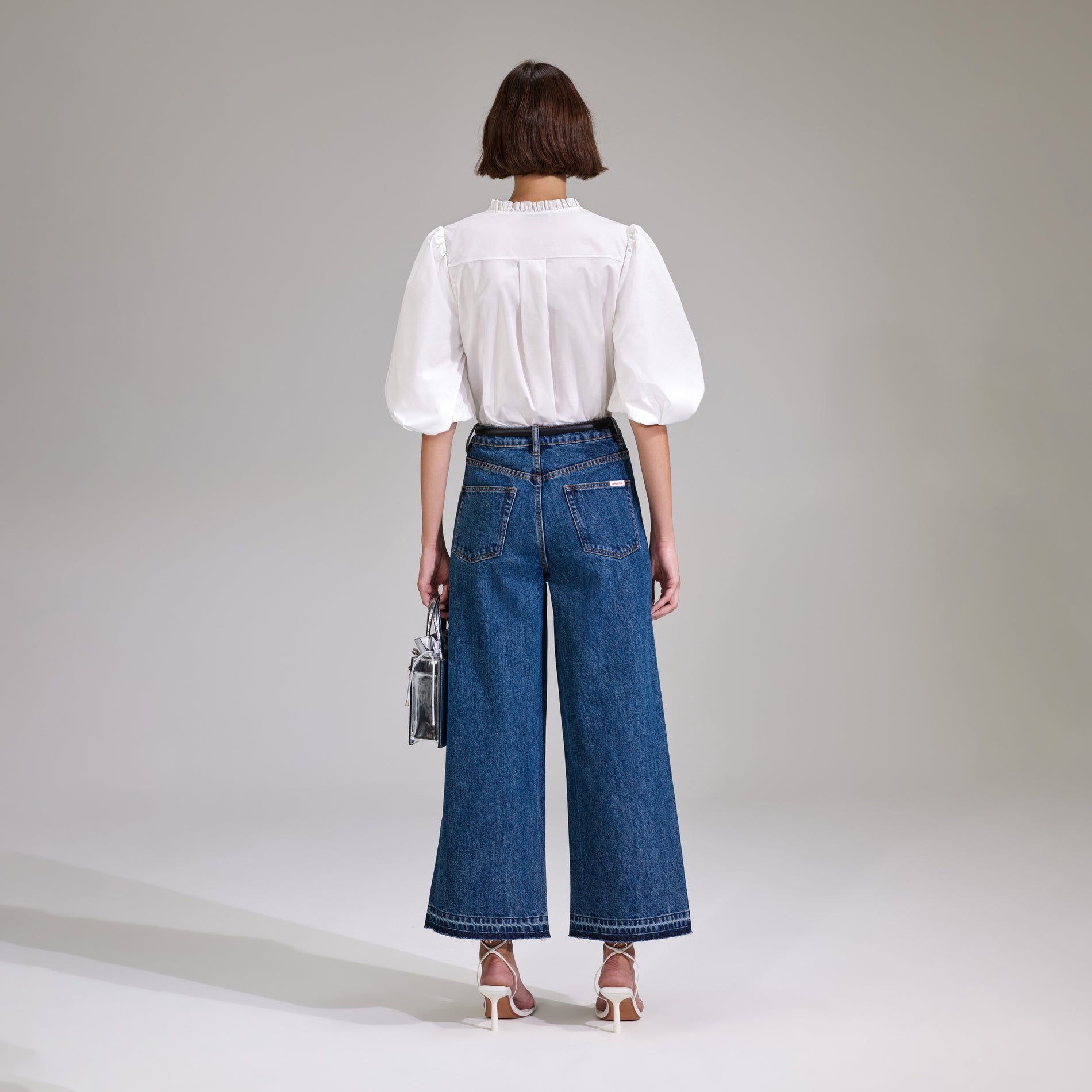 A woman wearing the White Cotton Poplin Top