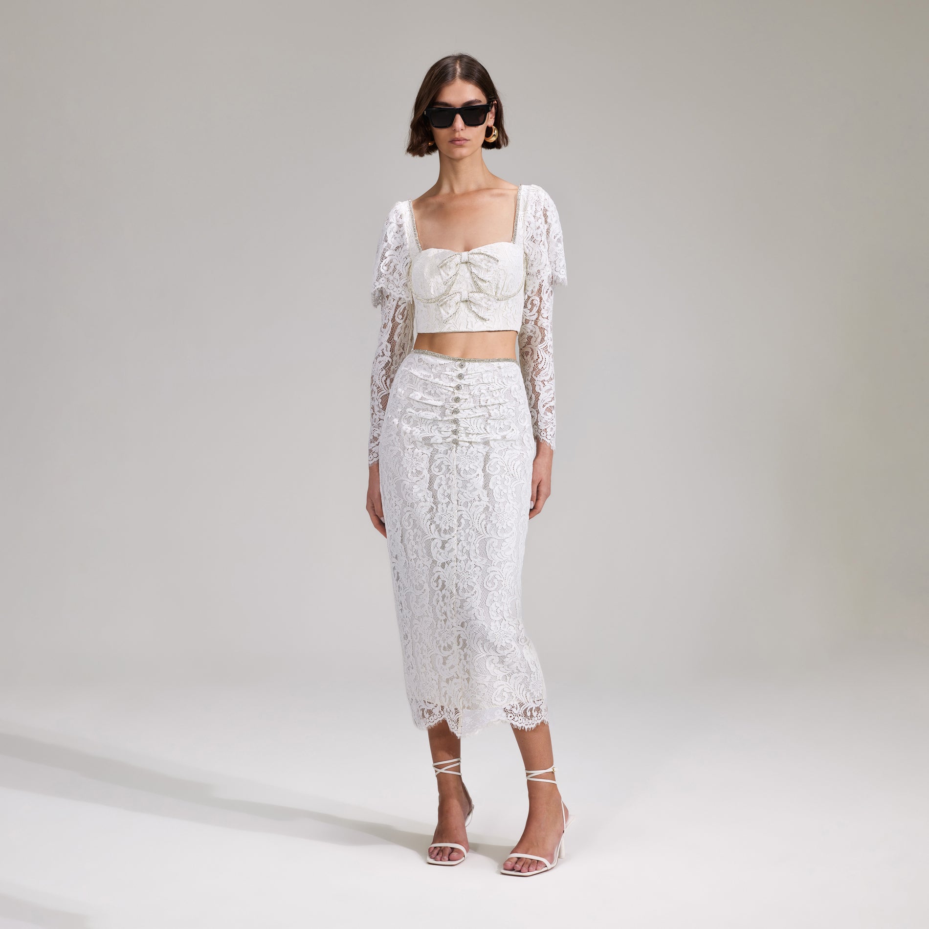 A woman wearing the Cream Cord Lace Midi Skirt