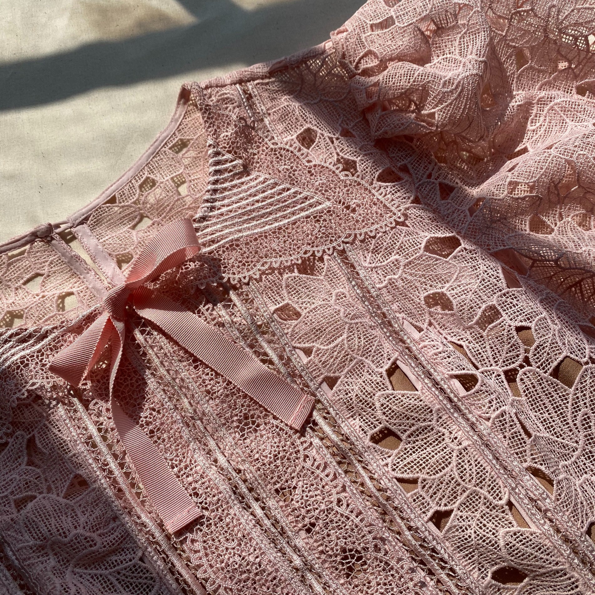 A close up of the fabric for the Blush Guipure Midi Dress
