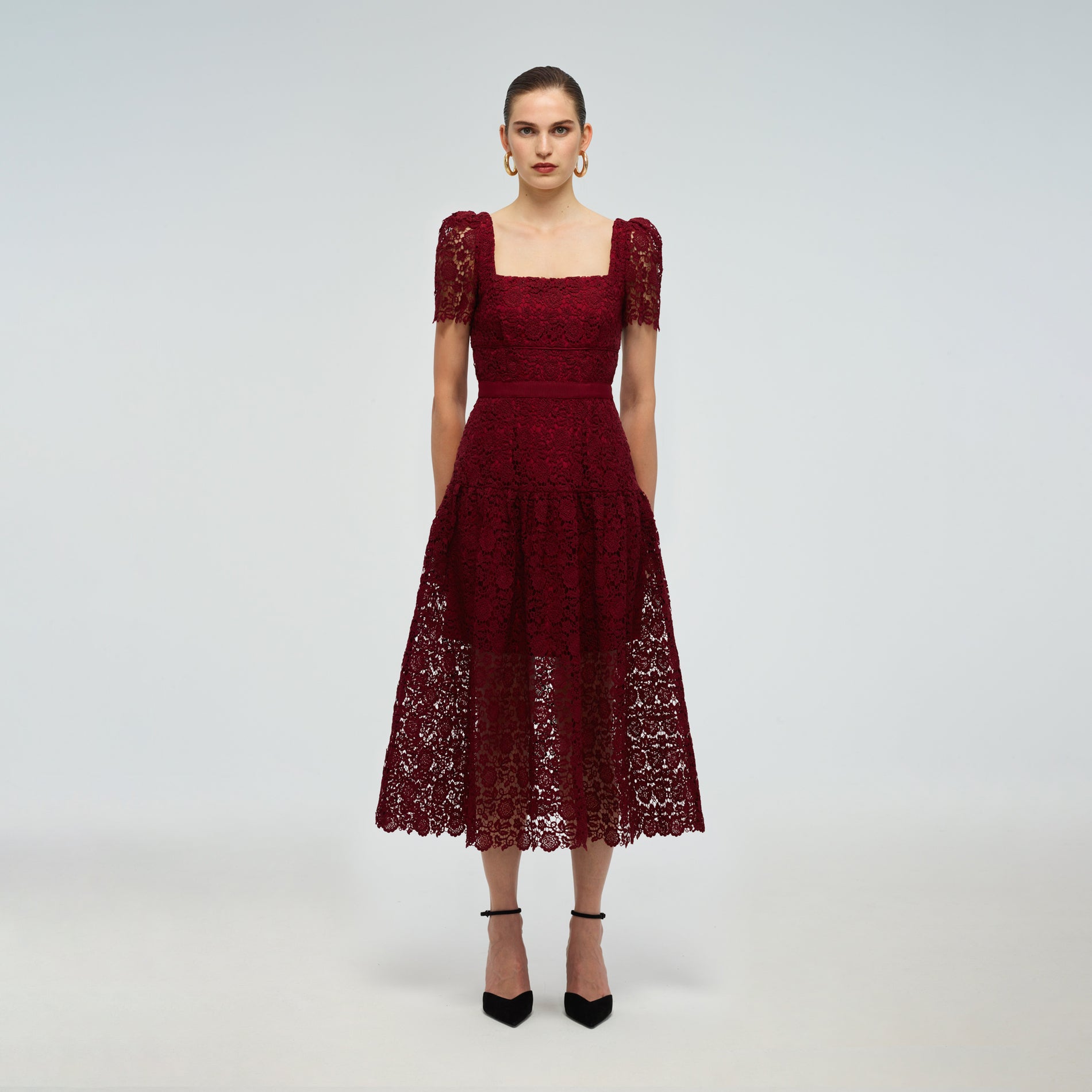 A woman wearing the Burgundy Guipure Lace Midi Dress