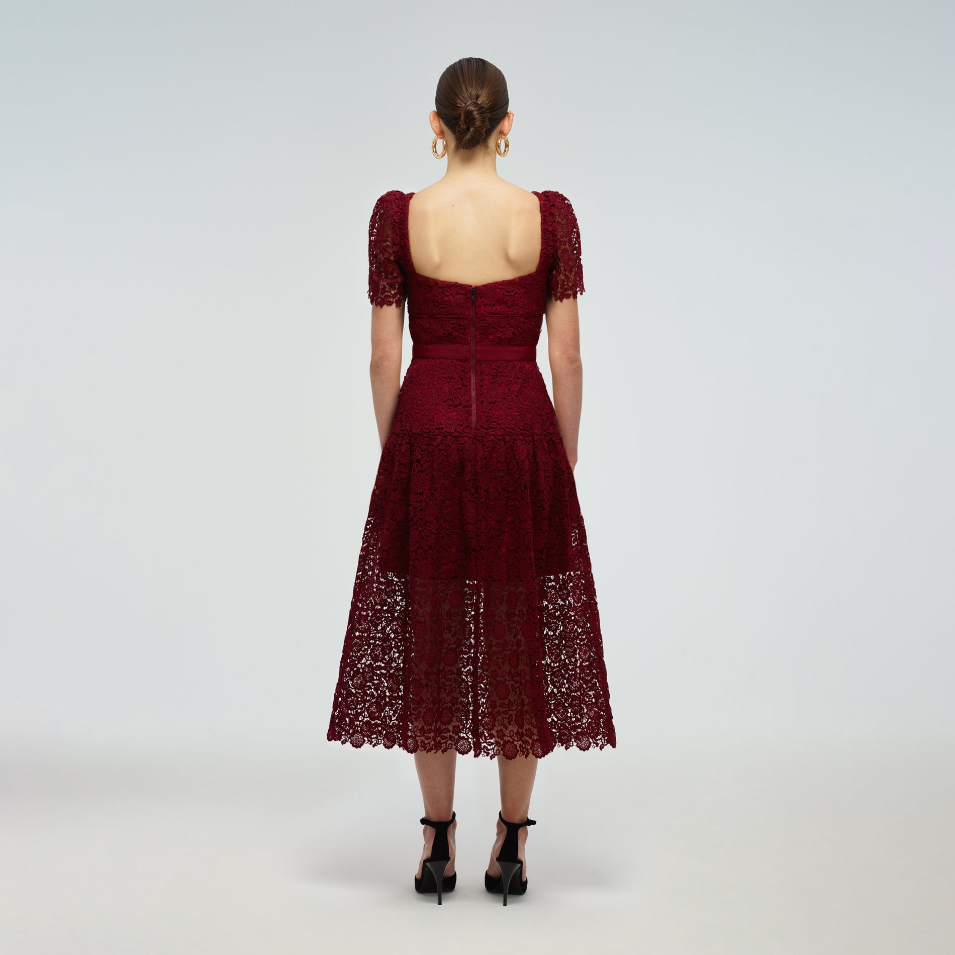 A woman wearing the Burgundy Guipure Lace Midi Dress