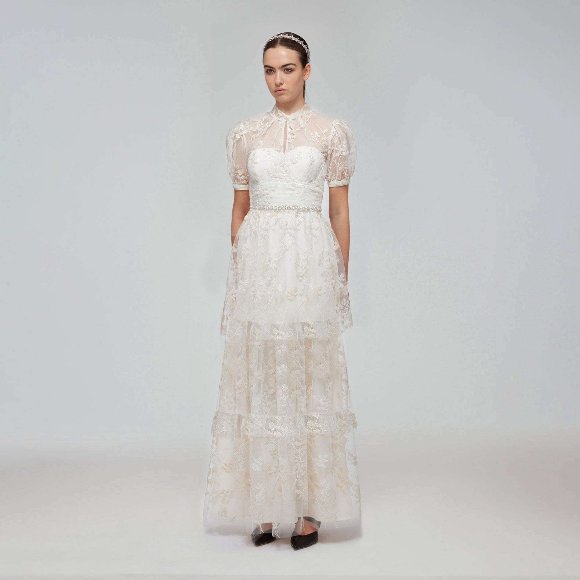 A woman wearing the Ivory Blossom Sequin Tiered Maxi Dress