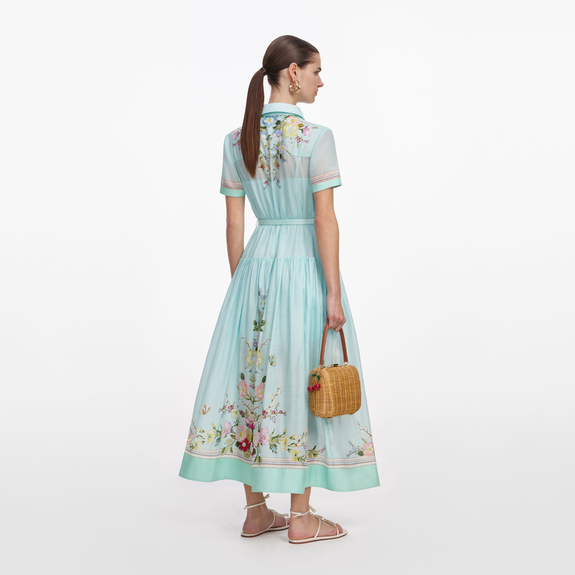 Back view of a woman wearing the Mint Floral Organza Midi Dress