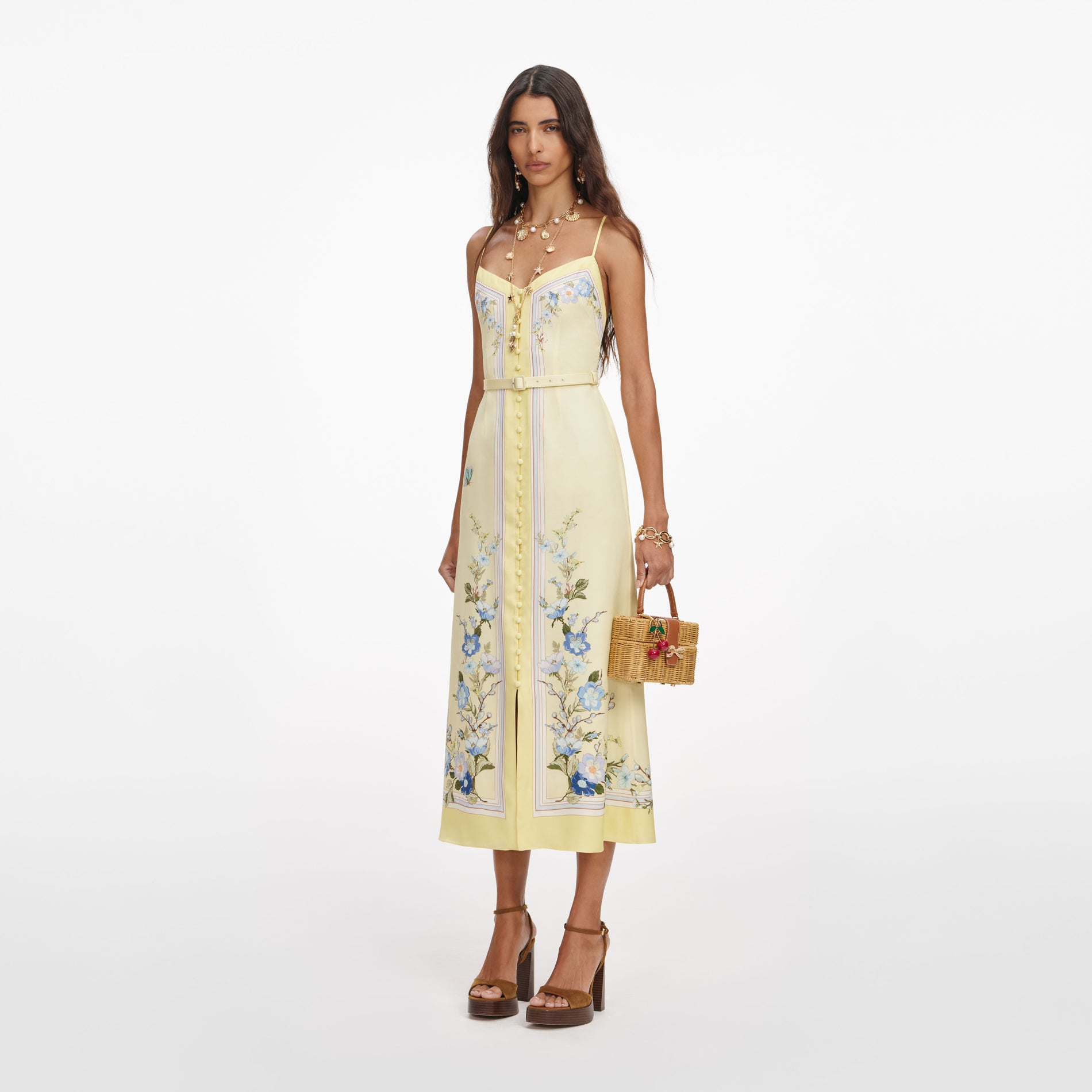 Side view of a woman wearing the Yellow Floral Silk Midi Dress