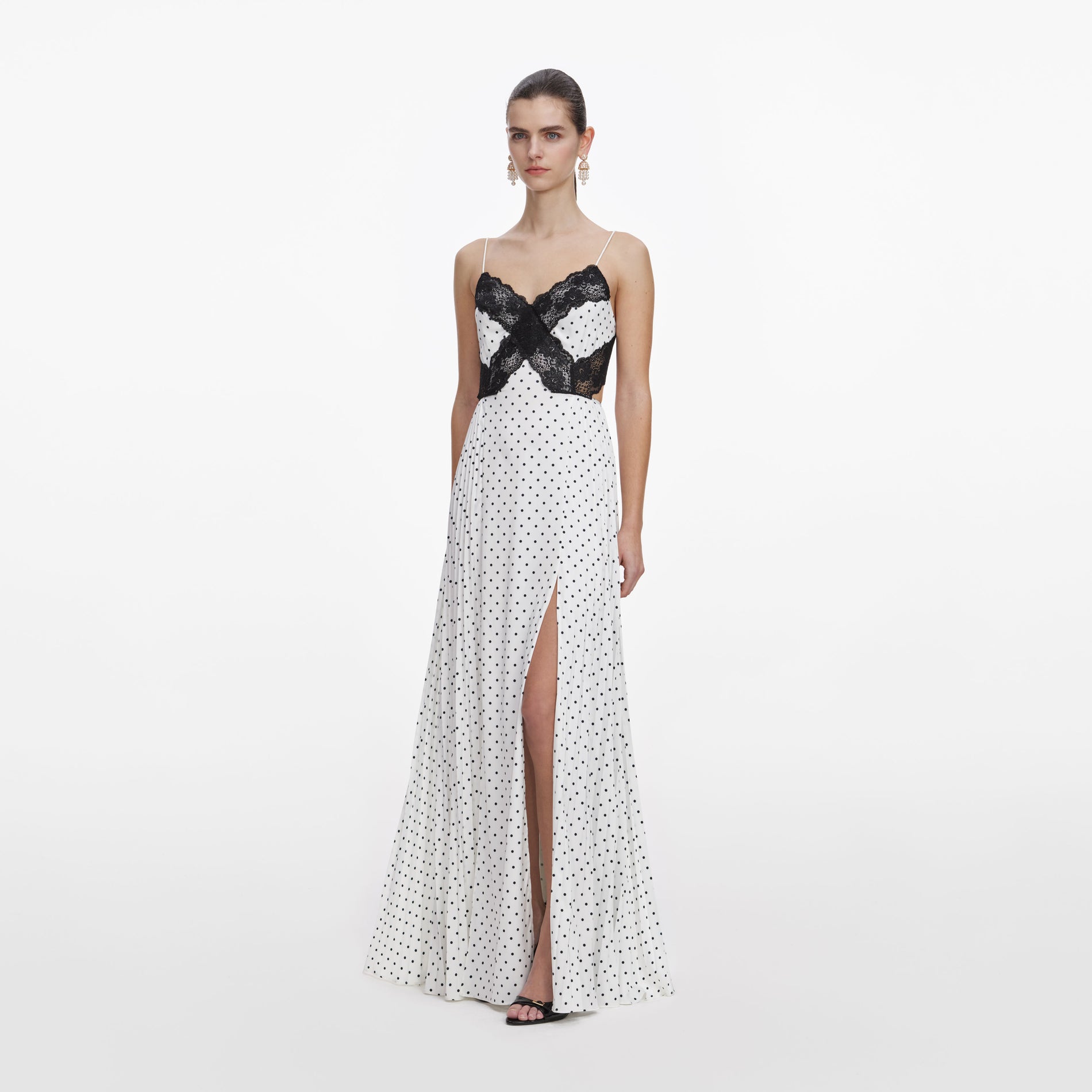 Side view of a woman wearing the White Polka Dot Satin Lace Maxi Dress