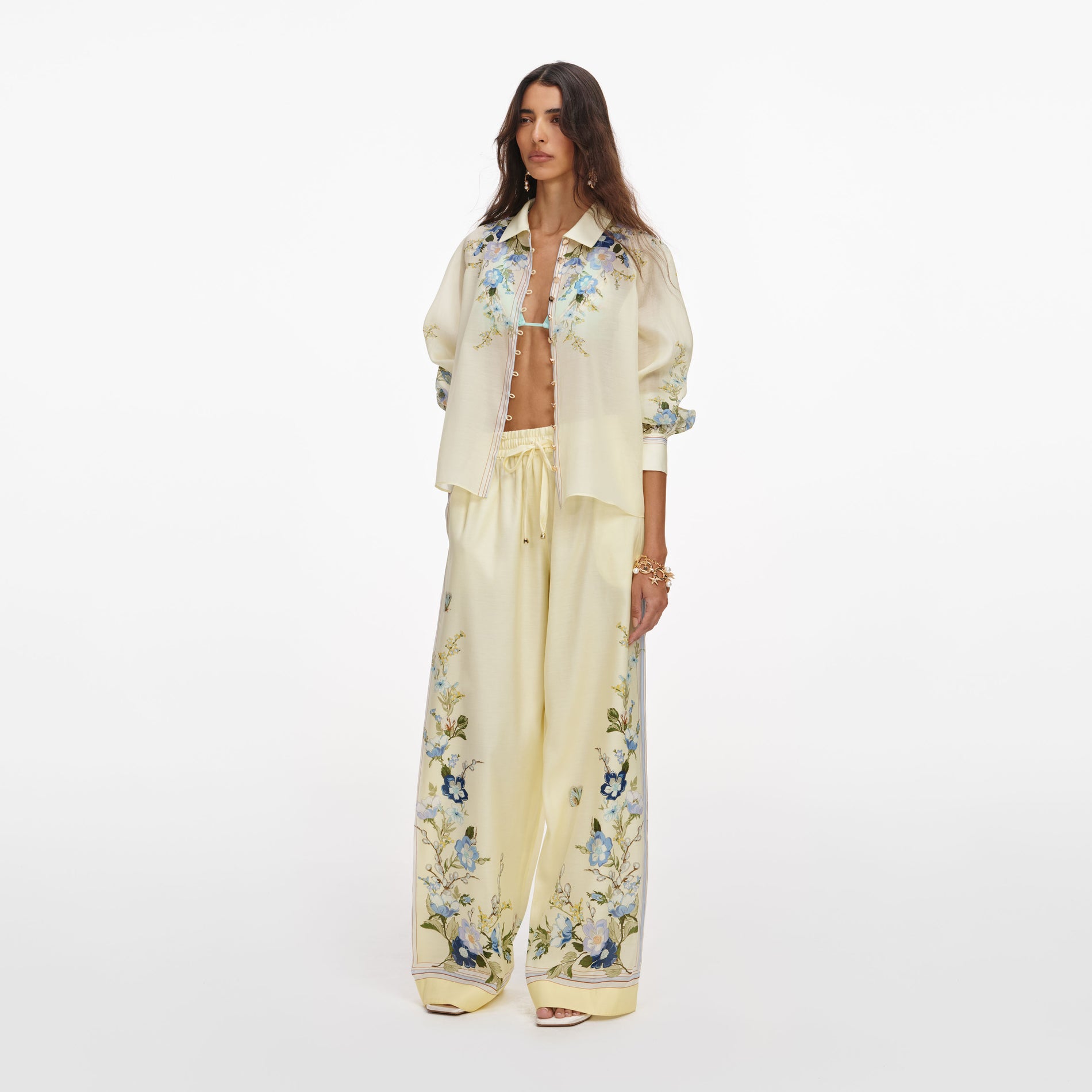 Side view of a woman wearing the Yellow Floral Organza Trousers