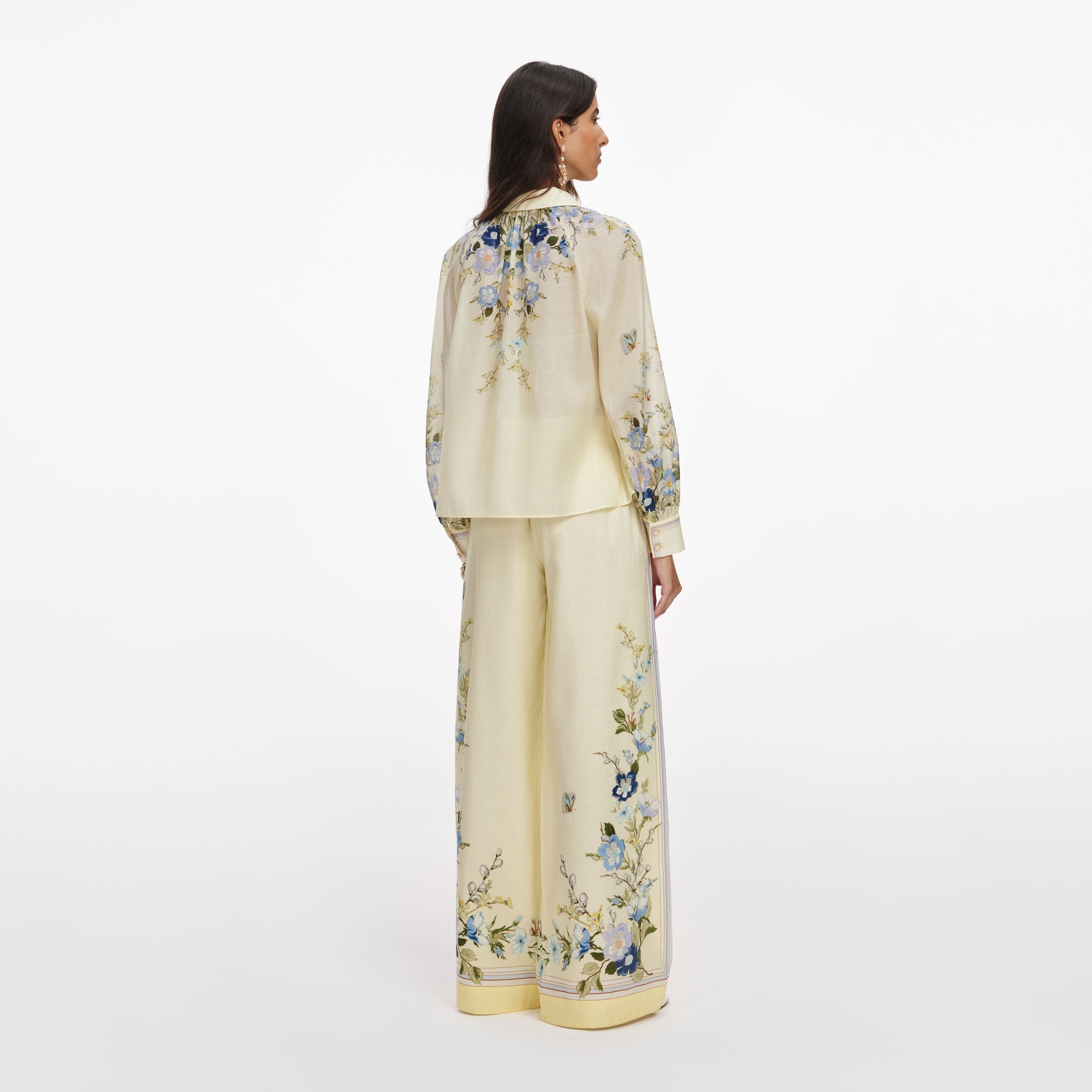Back view of a woman wearing the Yellow Floral Organza Trousers