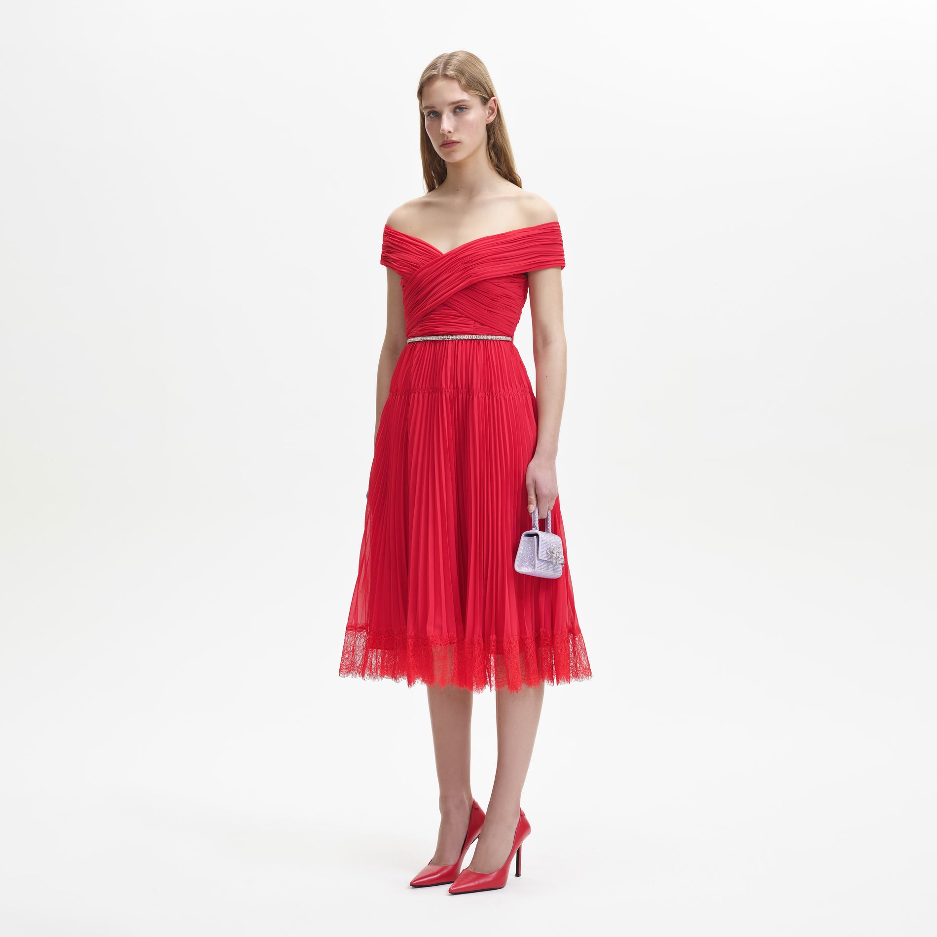 Side view of a woman wearing the Red Chiffon Off Shoulder Midi Dress