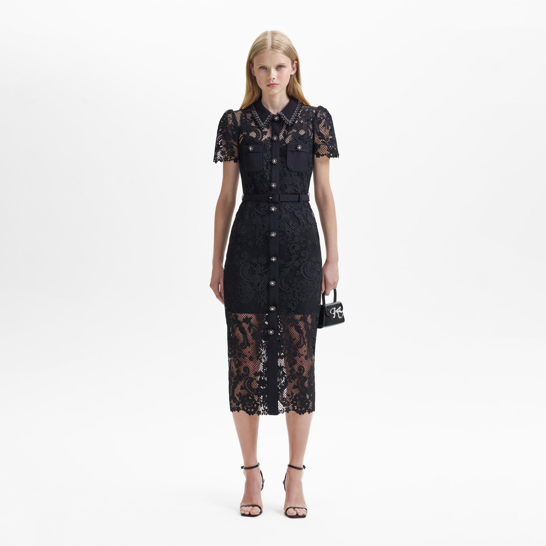 A woman wearing the Black Lace Button Front Midi Dress