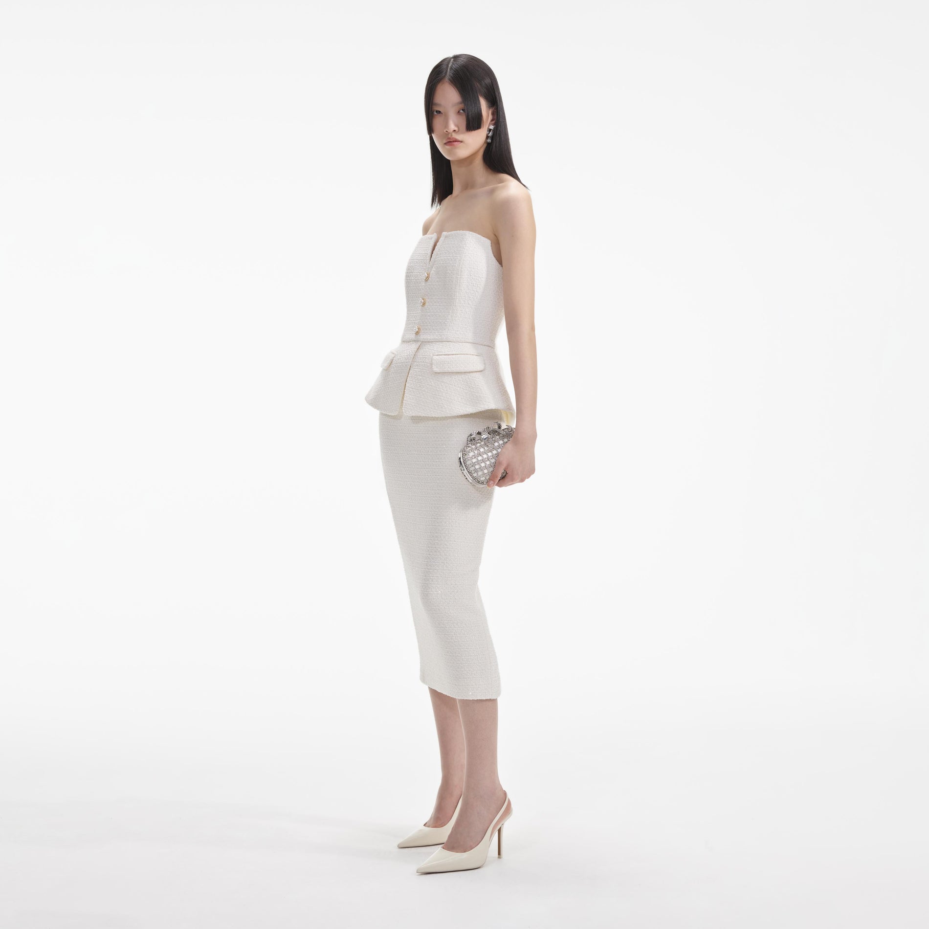 Side view of a woman wearing the Cream Tinsel Boucle Bandeau Midi Dress