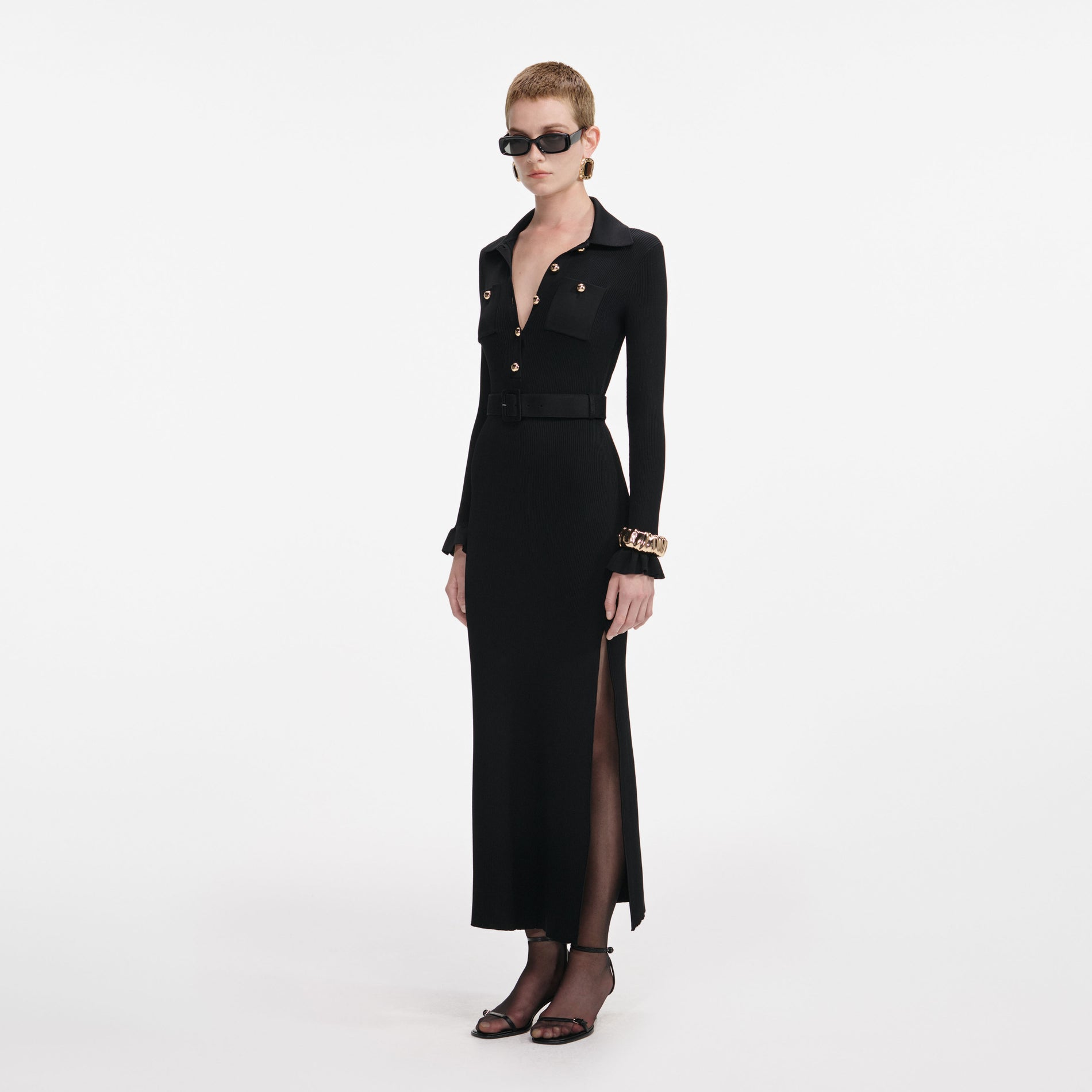 Side view of a woman wearing the Black Ribbed Knit Maxi Dress