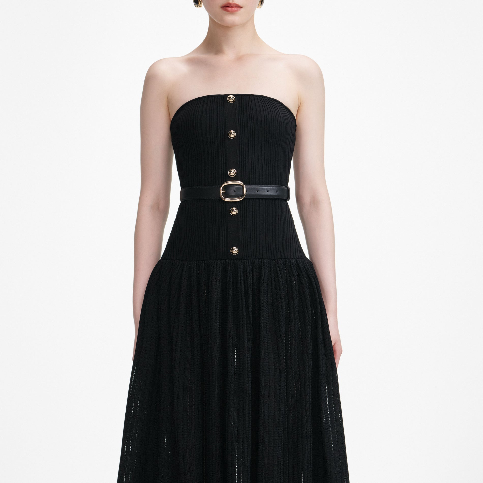 A close up of a woman wearing the Black Bandeau Knit Maxi Dress