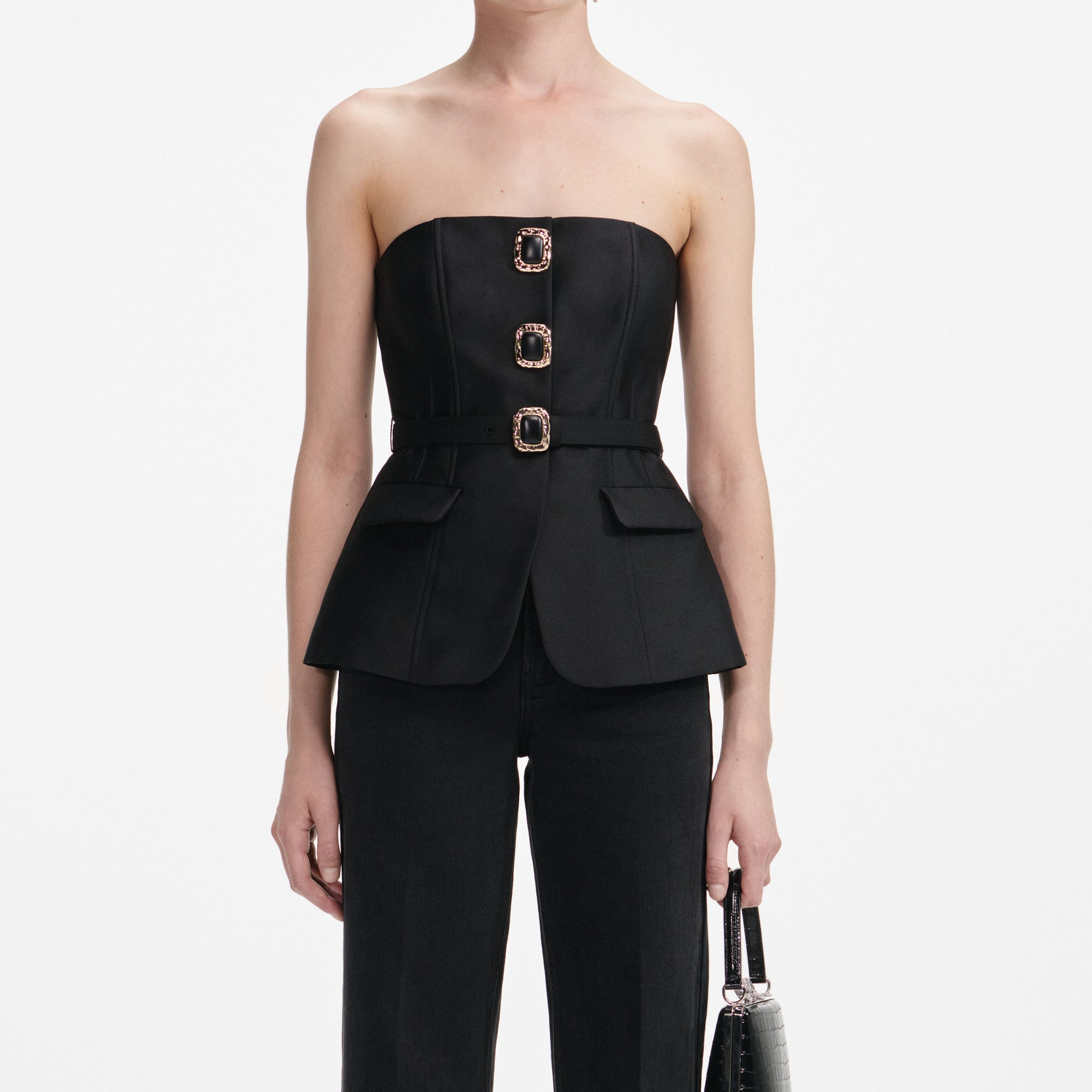 A close up of a woman wearing the Black Taffeta Bandeau Jumpsuit