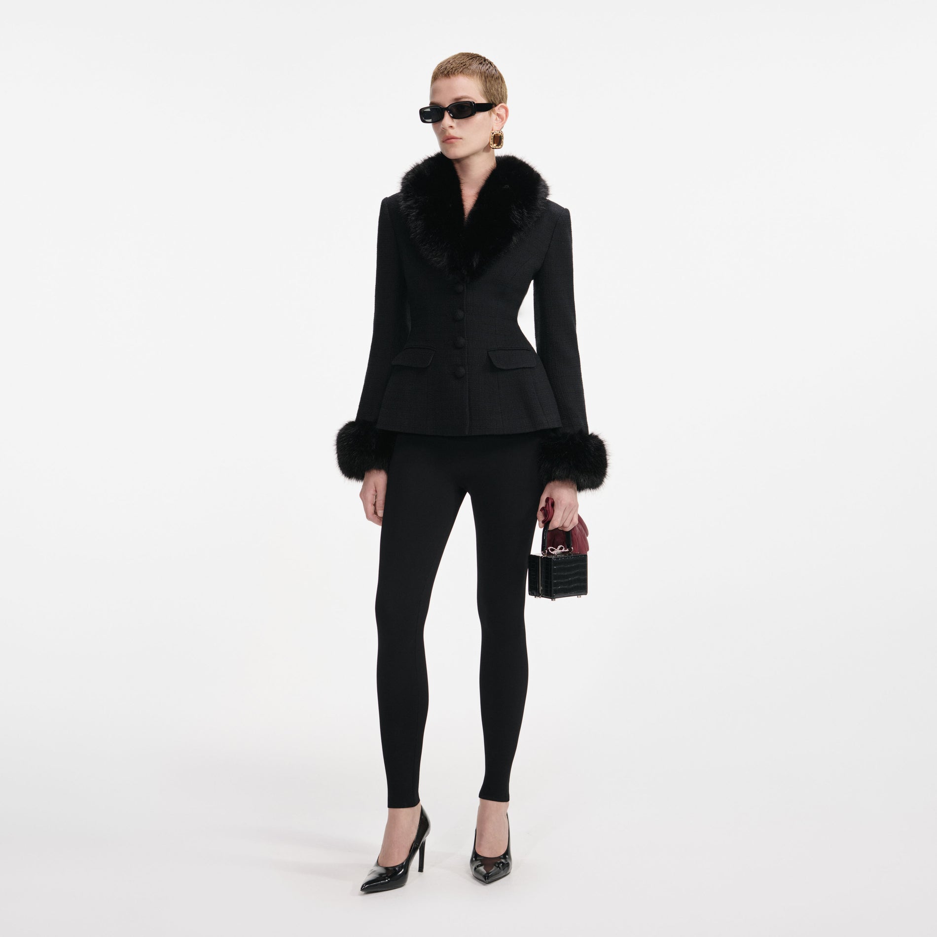 Side view of a woman wearing the Black Tailored Boucle Fur Jacket