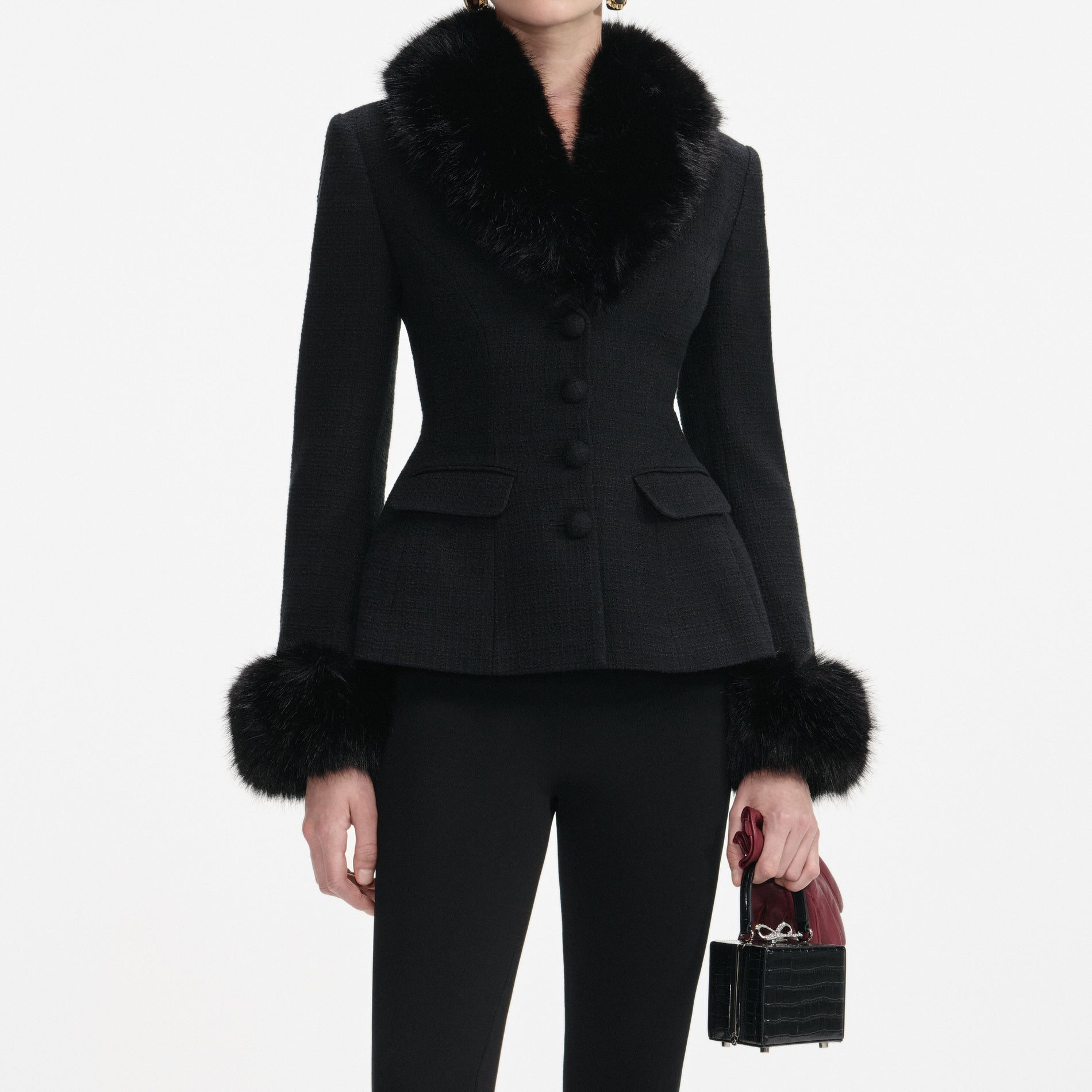 A close up of a woman wearing the Black Tailored Boucle Fur Jacket