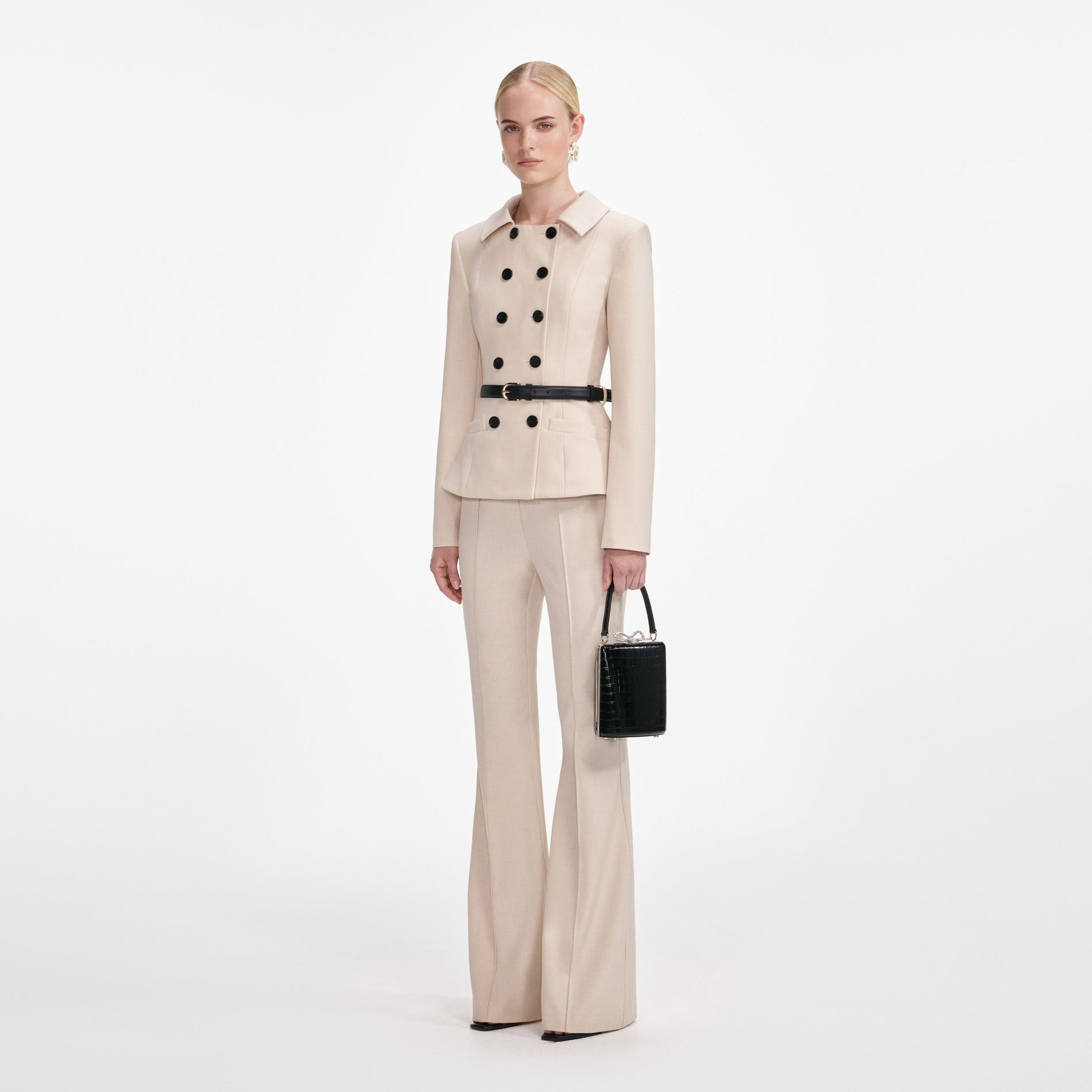 Side view of a woman wearing the Beige Twill Jumpsuit