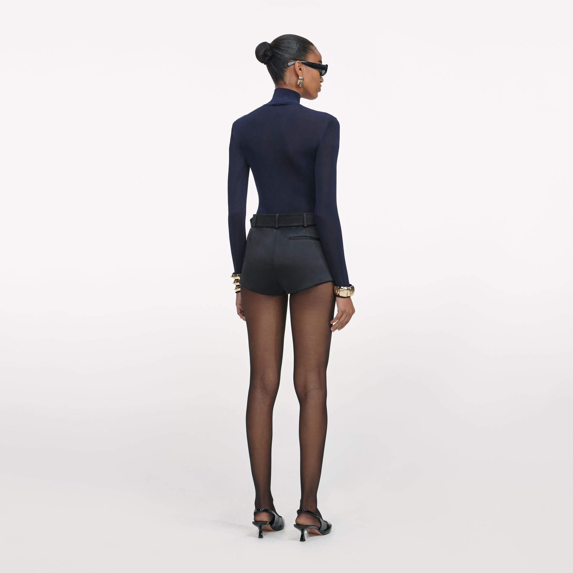 Back view of a woman wearing the Black Satin Shorts
