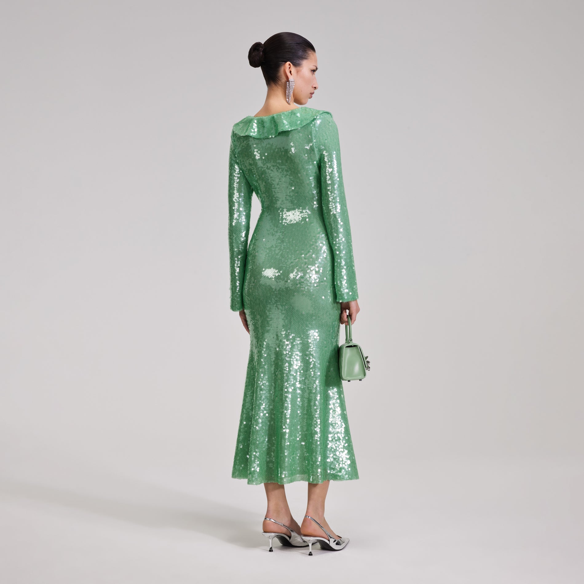 A woman wearing the Green Sequin Midi Dress
