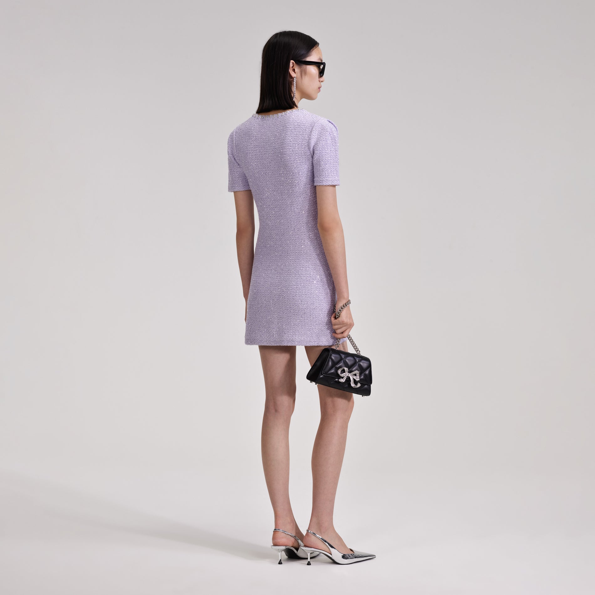 A woman wearing the Lilac Sequin Knit Mini Dress