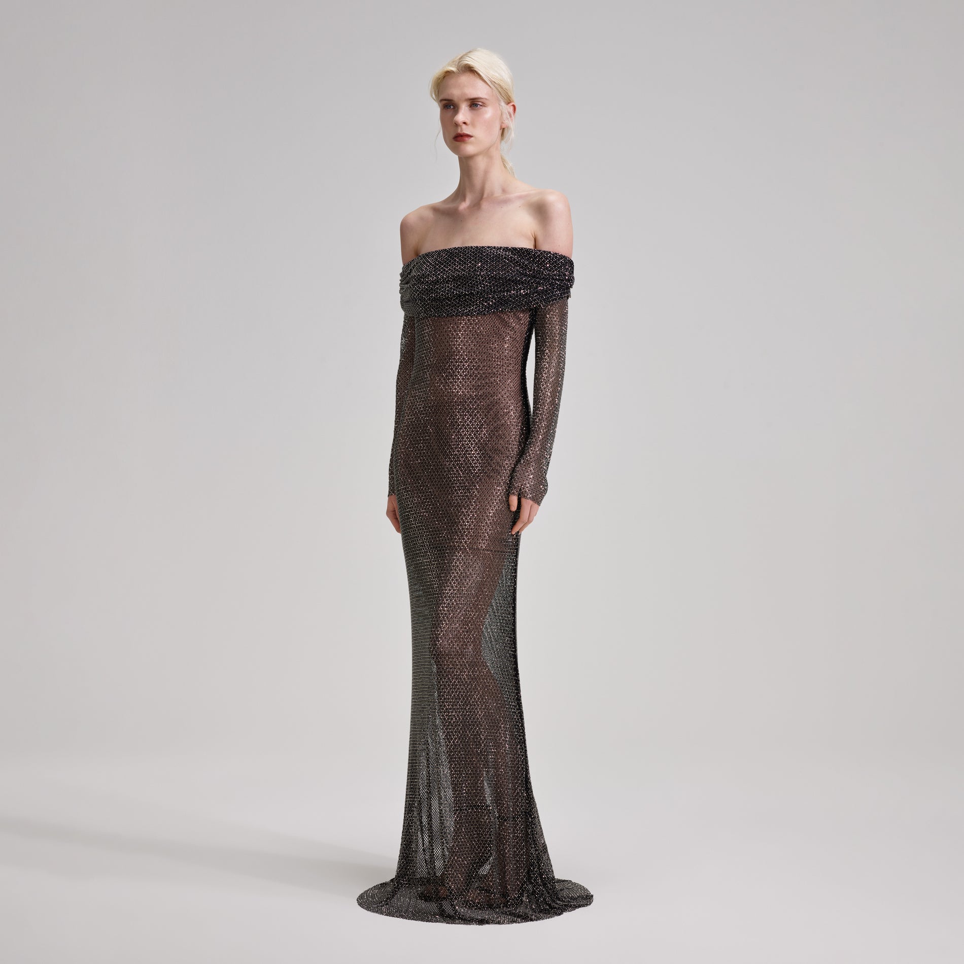 A woman wearing the Black Rhinestone Fishnet Maxi Dress