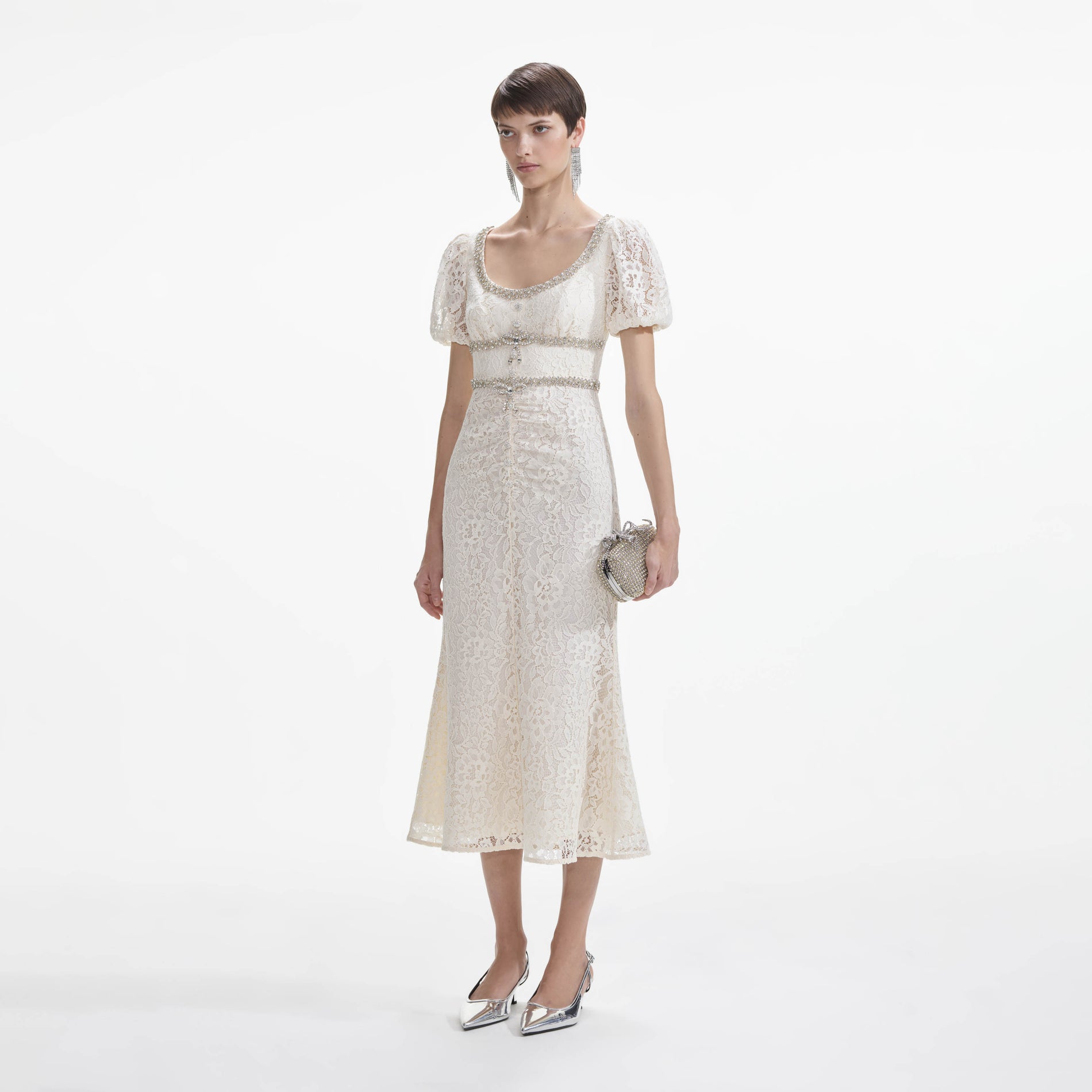 Side view of a woman wearing the Cream Lace Diamante Trim Midi Dress