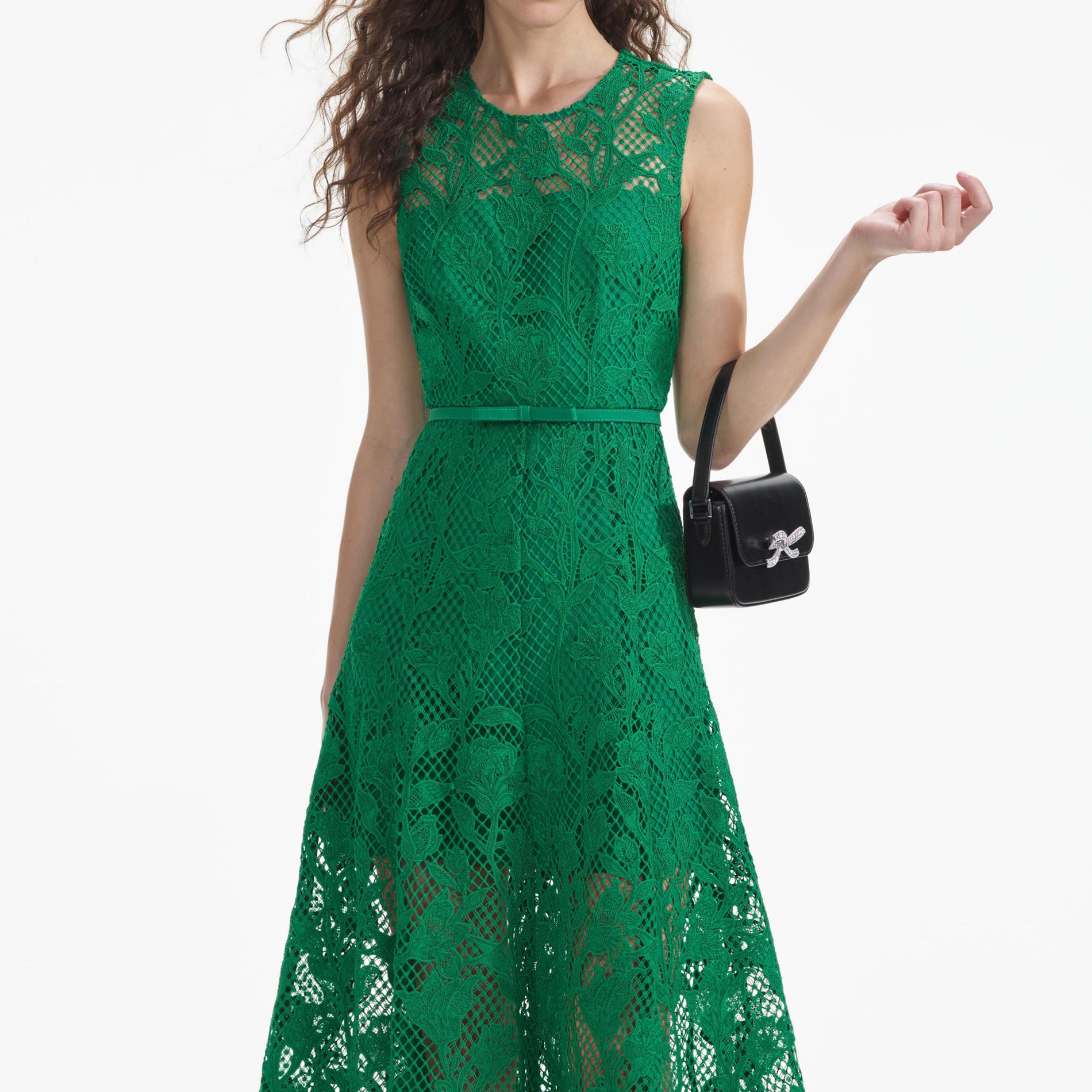 A close up of a woman wearing the Green Lace Sleeveless Midi Dress