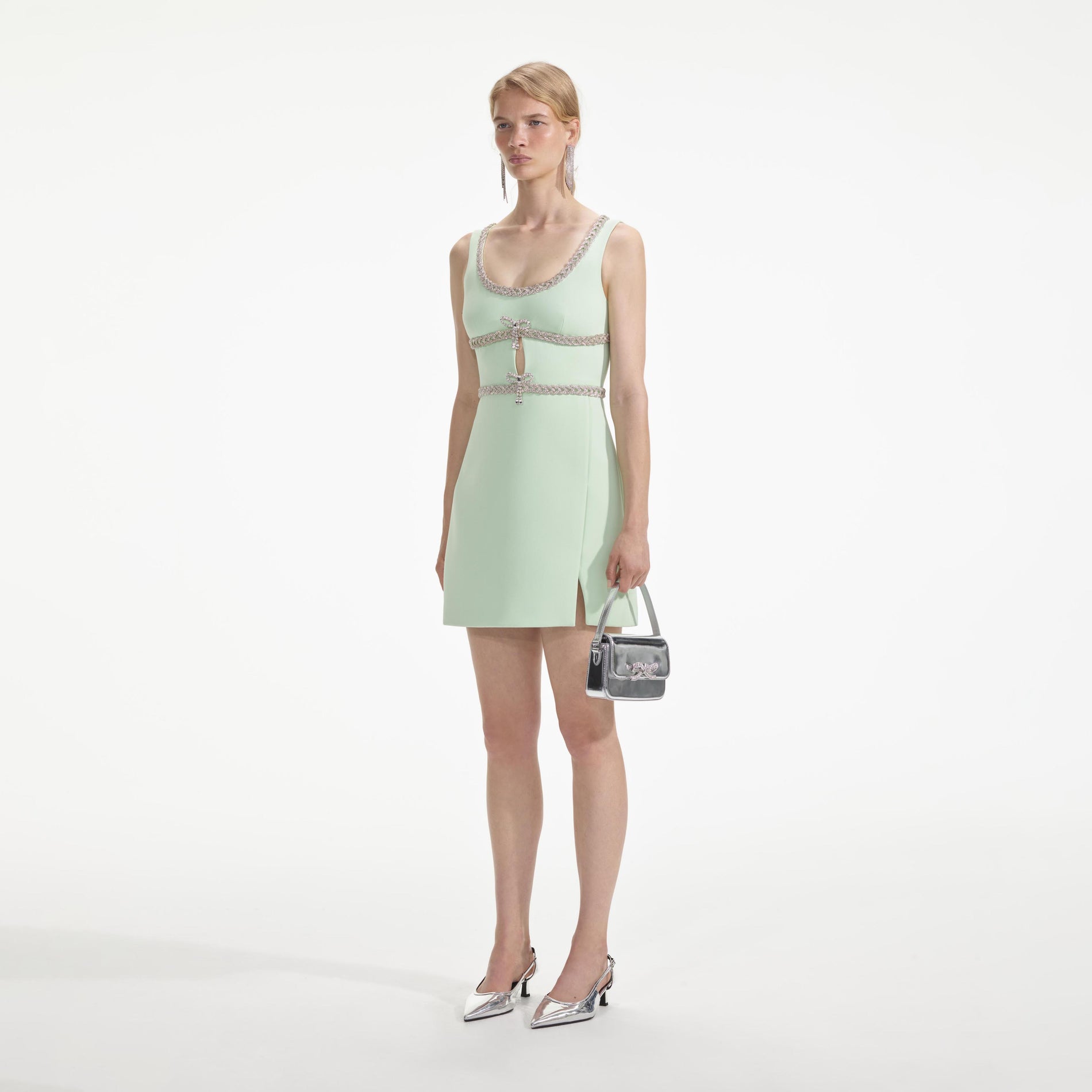 Side view of a woman wearing the Mint Diamante Bow Trim Mini Dress