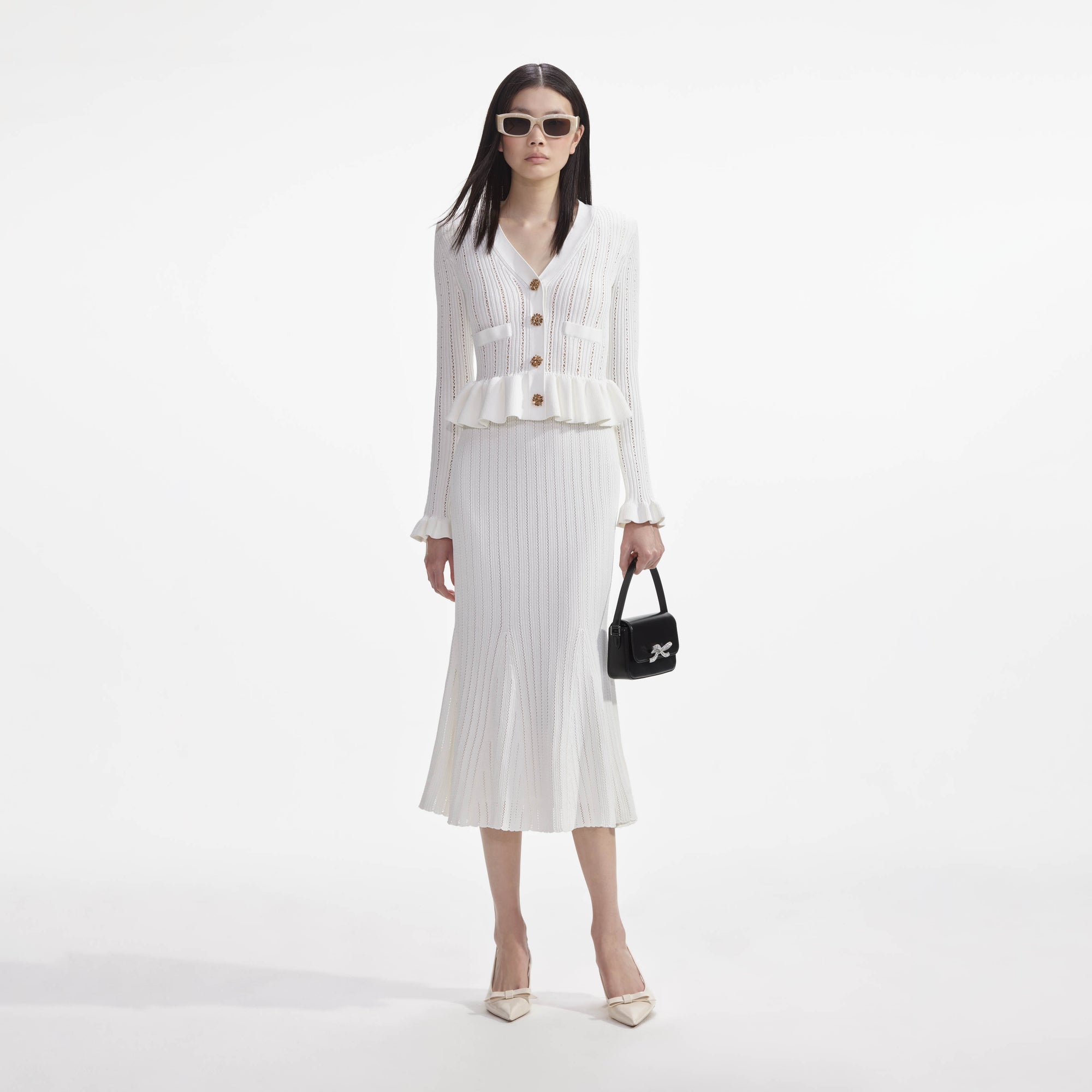Front view of a woman wearing the White Knit Peplum Midi Dress
