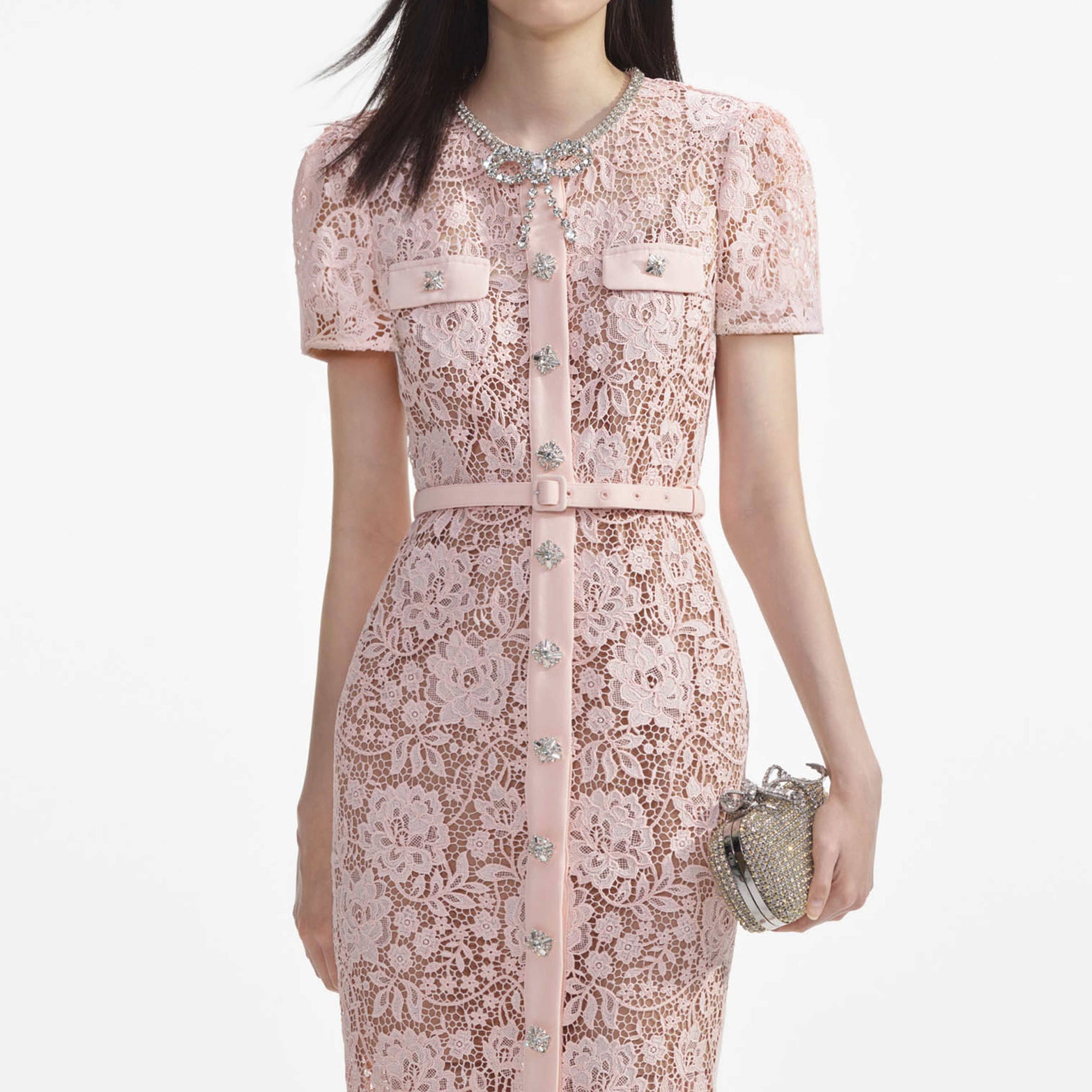 A close up of a woman wearing the Pink Lace Diamante Bow Midi Dress
