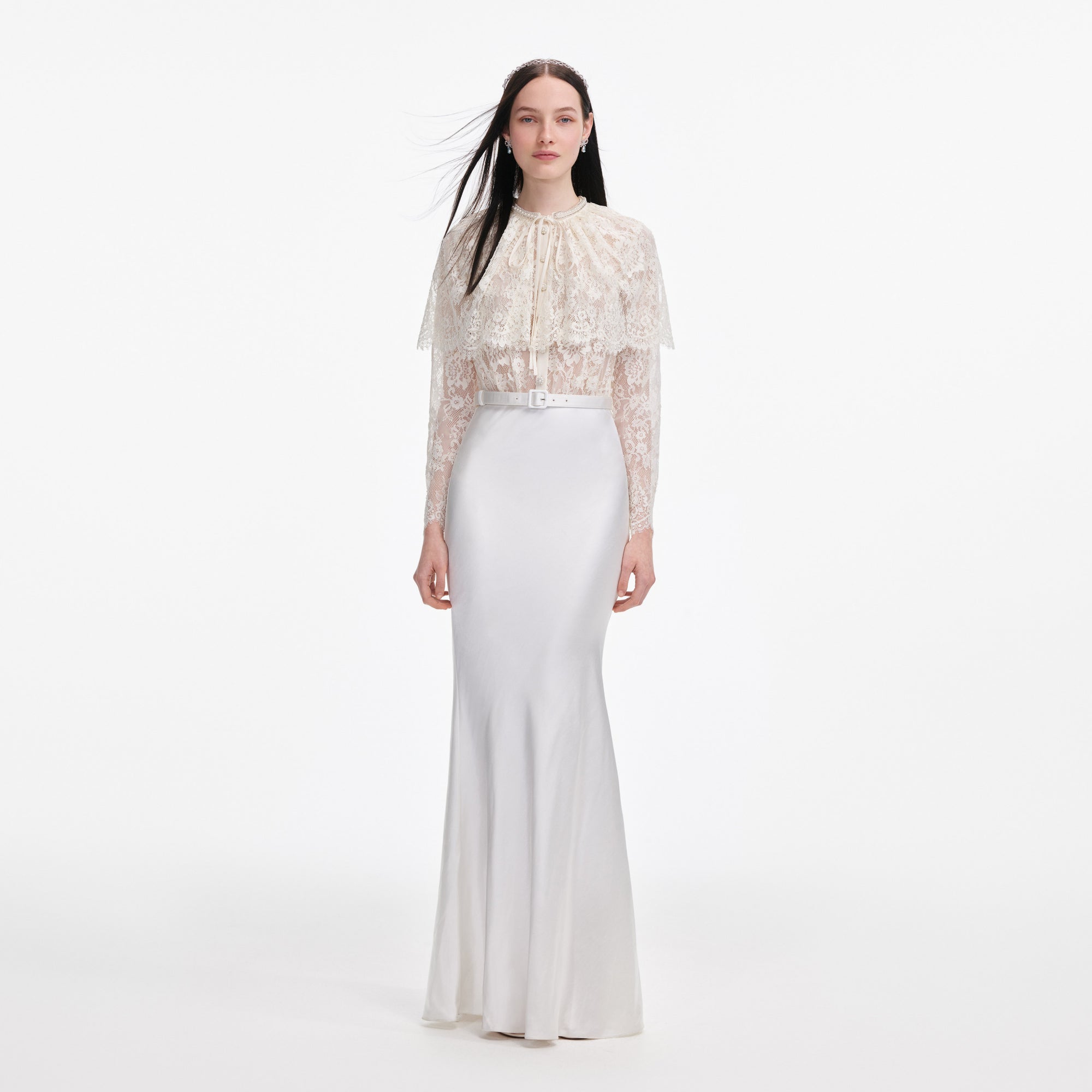 Front view of a woman wearing the White Lace Cape Maxi Dress