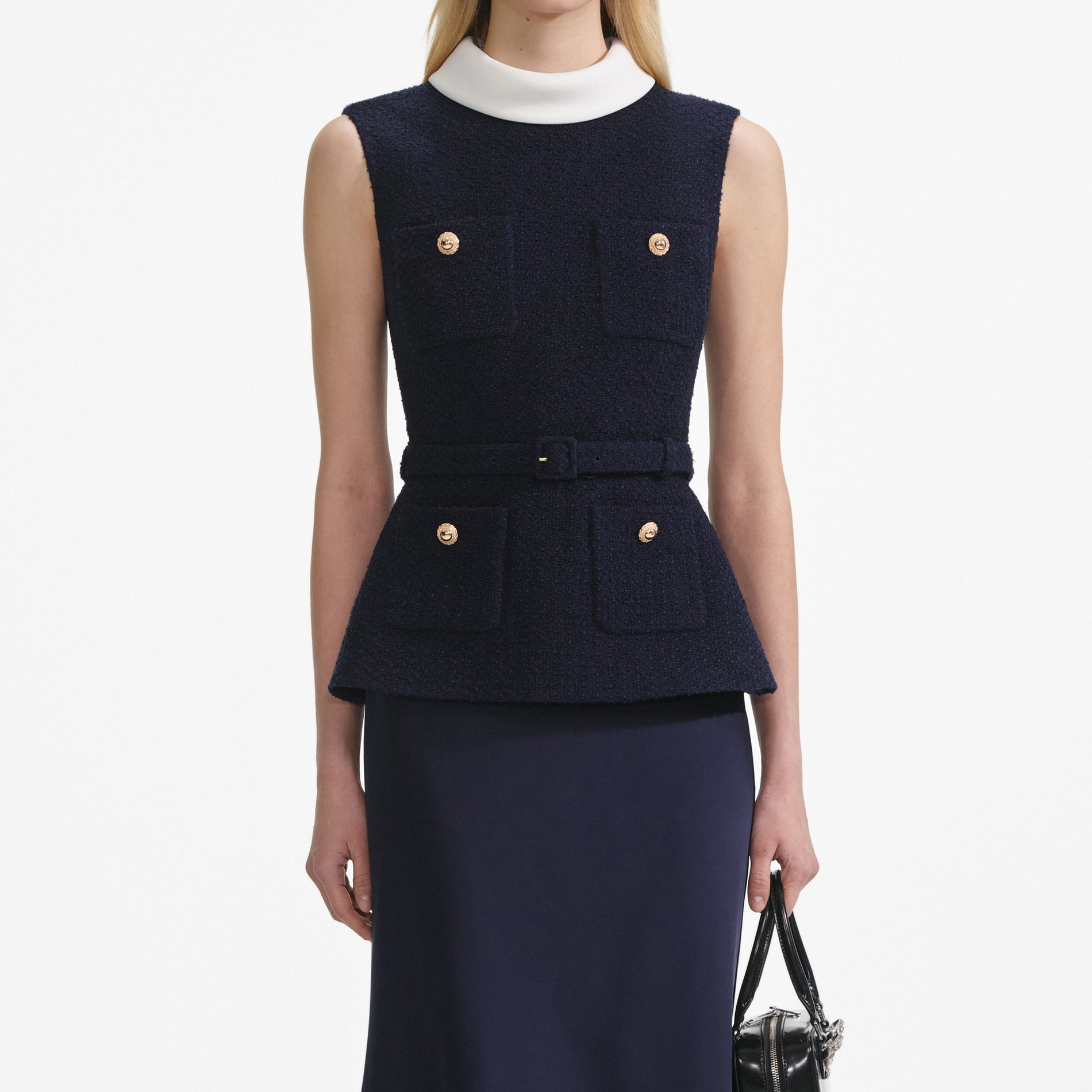 A close up of a woman wearing the Navy Boucle Sleeveless Midi Dress