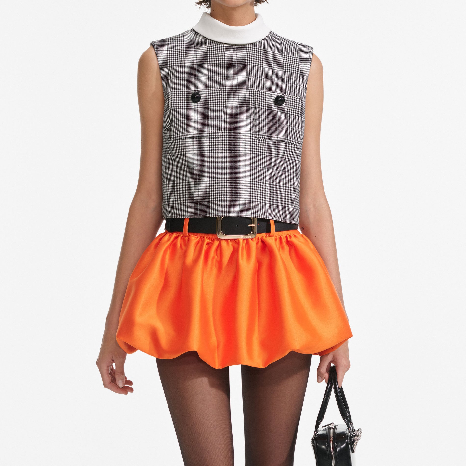 A close up of a woman wearing the Prince Of Wales Check Top