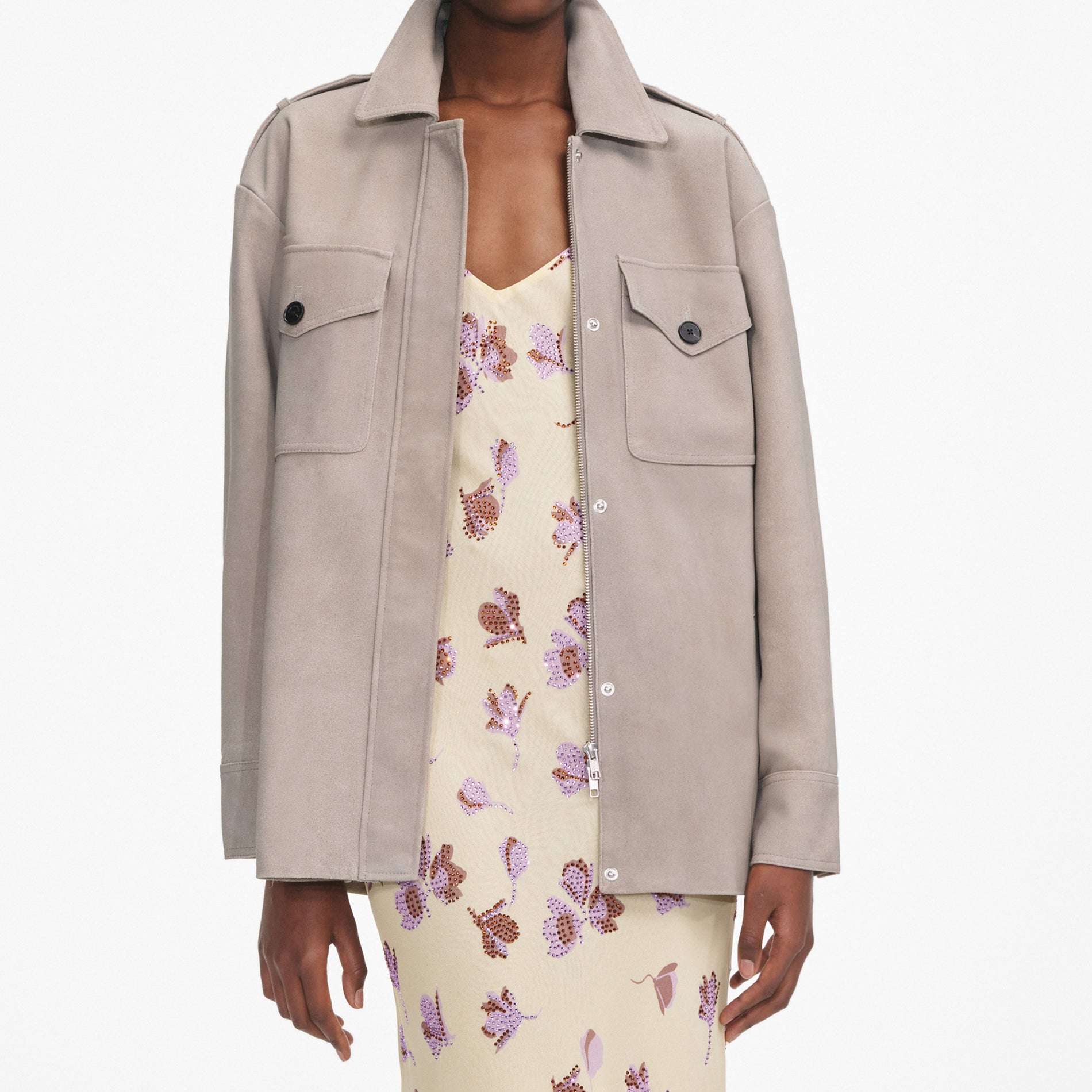 A close up of a woman wearing the Grey Suede Jacket