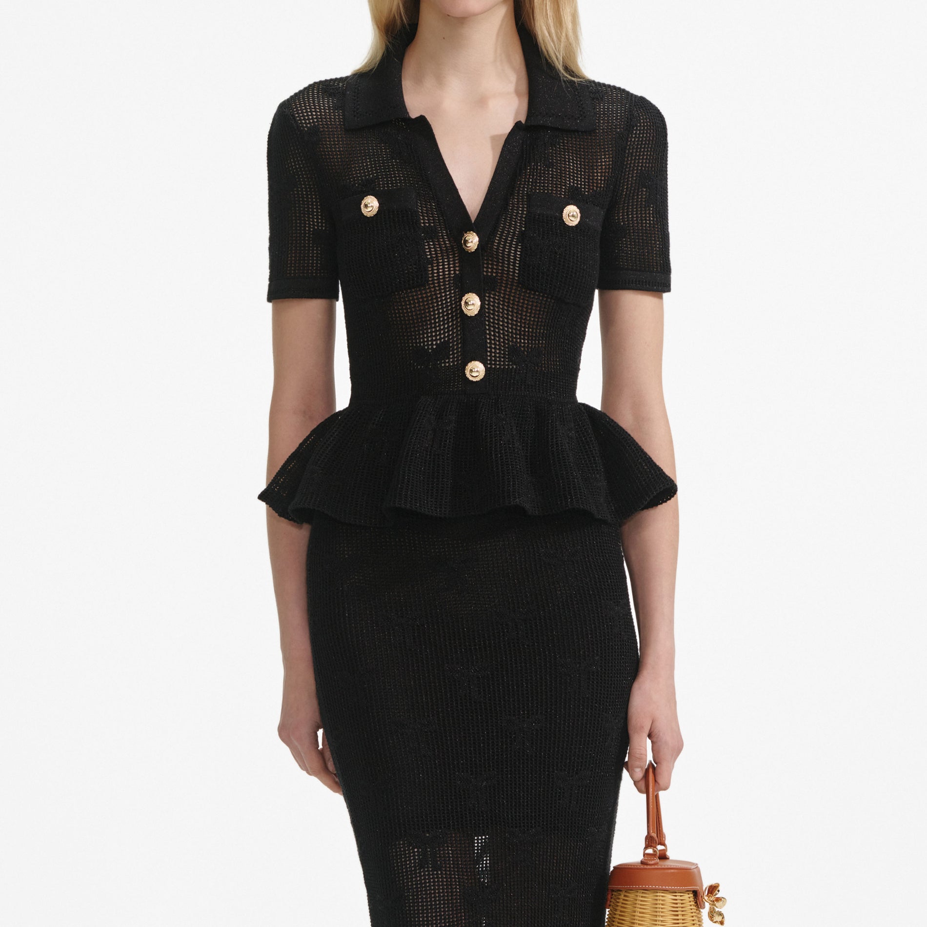 A close up of a woman wearing the Black Bow Crochet Midi Dress