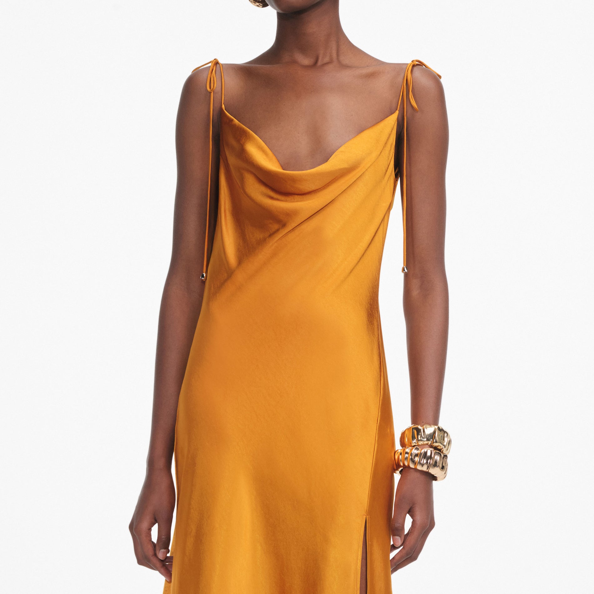 A close up of a woman wearing the Burnt Orange Satin Midi Dress