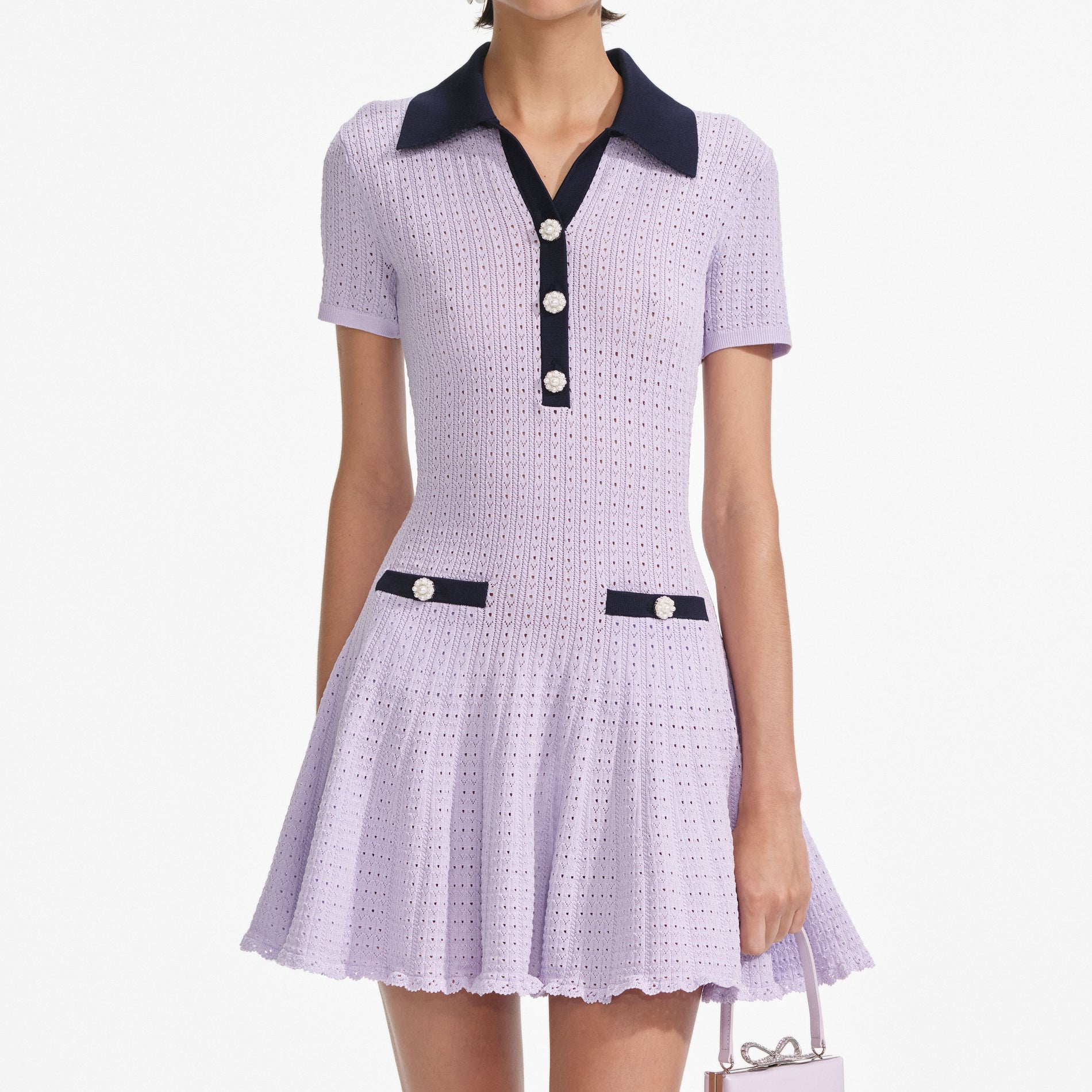A close up of a woman wearing the Lilac Pointelle Knit Mini Dress