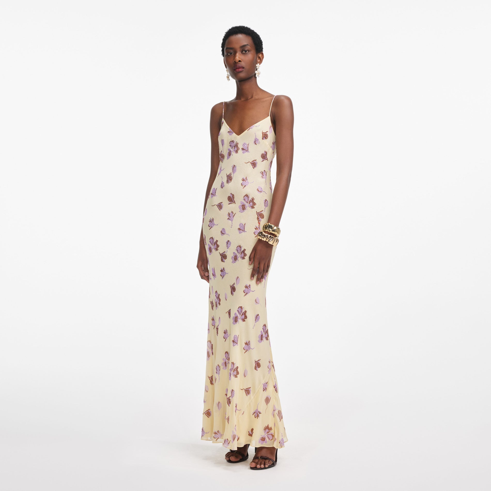 Side view of a woman wearing the Yellow Floral Rhinestone Maxi Dress