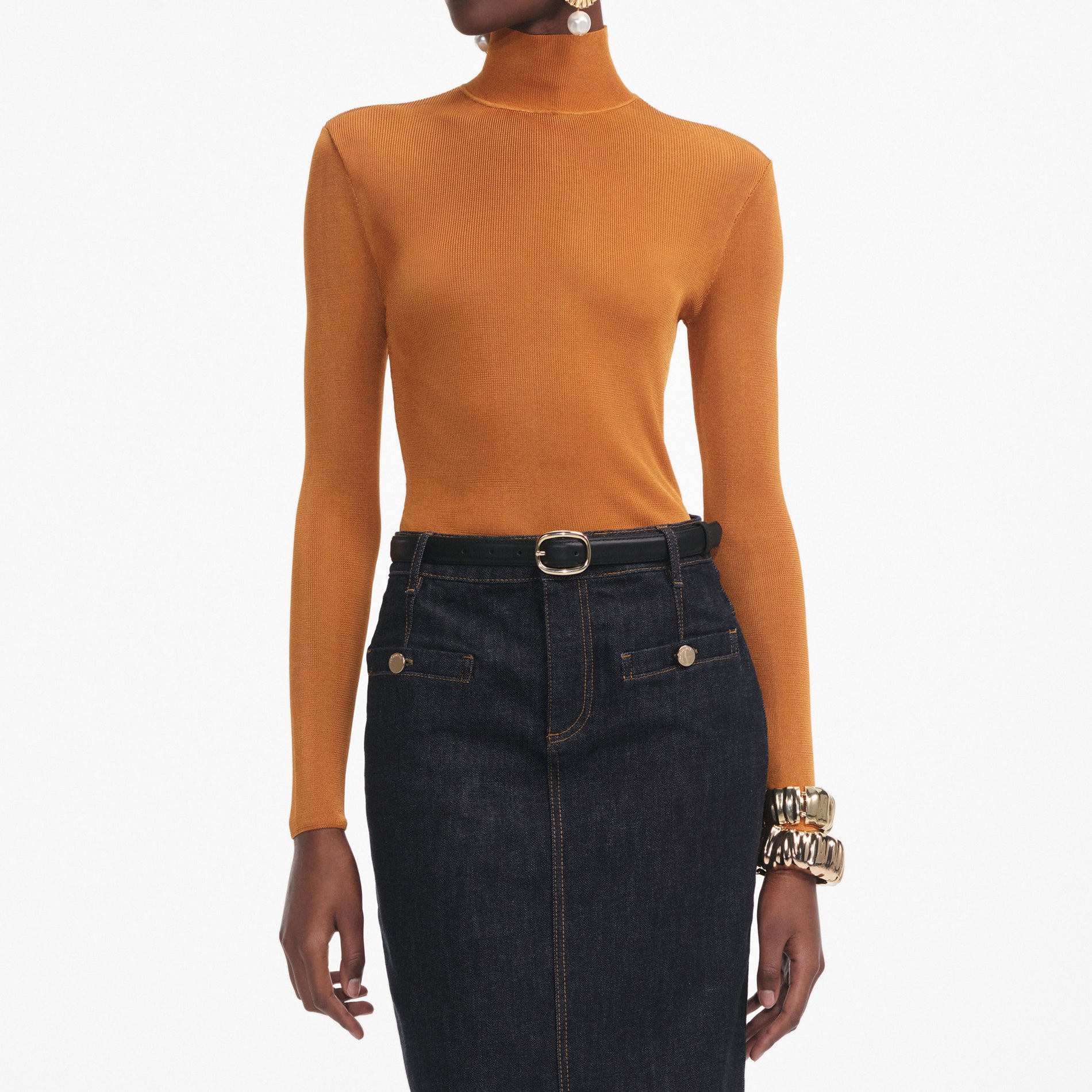 A close up of a woman wearing the Burnt Orange Viscose Knit Top